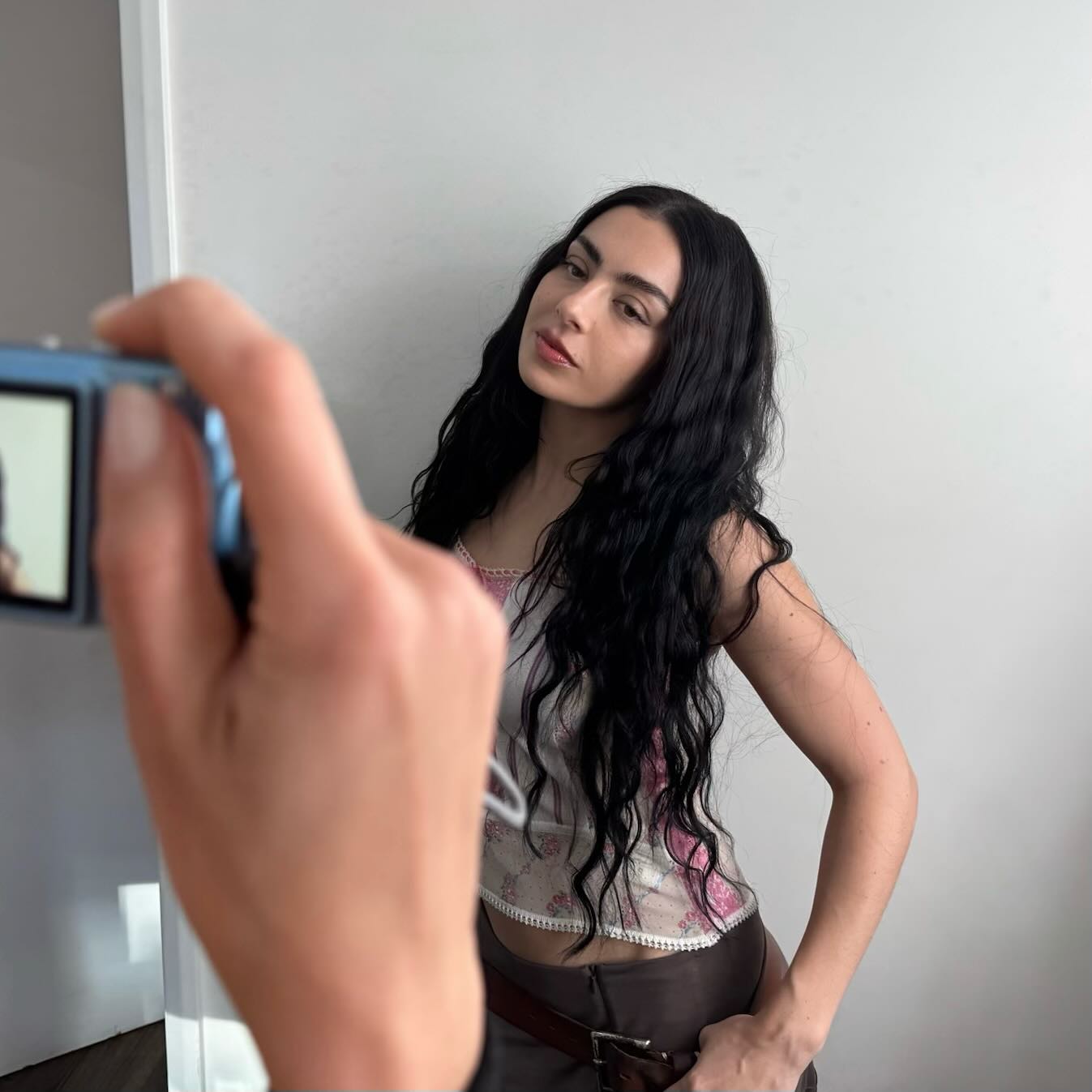 Celebrity makeup artist Yasmin Istanbouli taking a picture of Charli XCX.