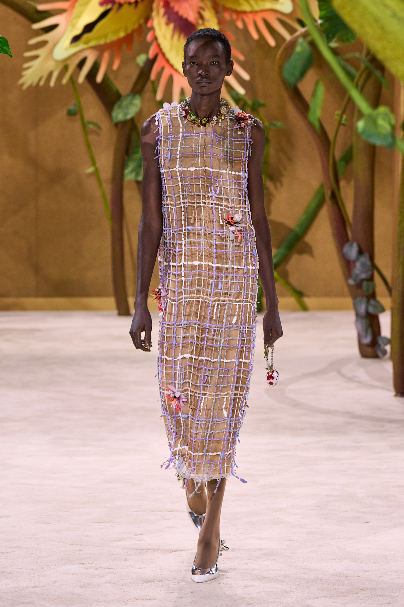 A model walking in the Chanel F/W 26 Haute Couture Show in Paris wearing metallic heels.