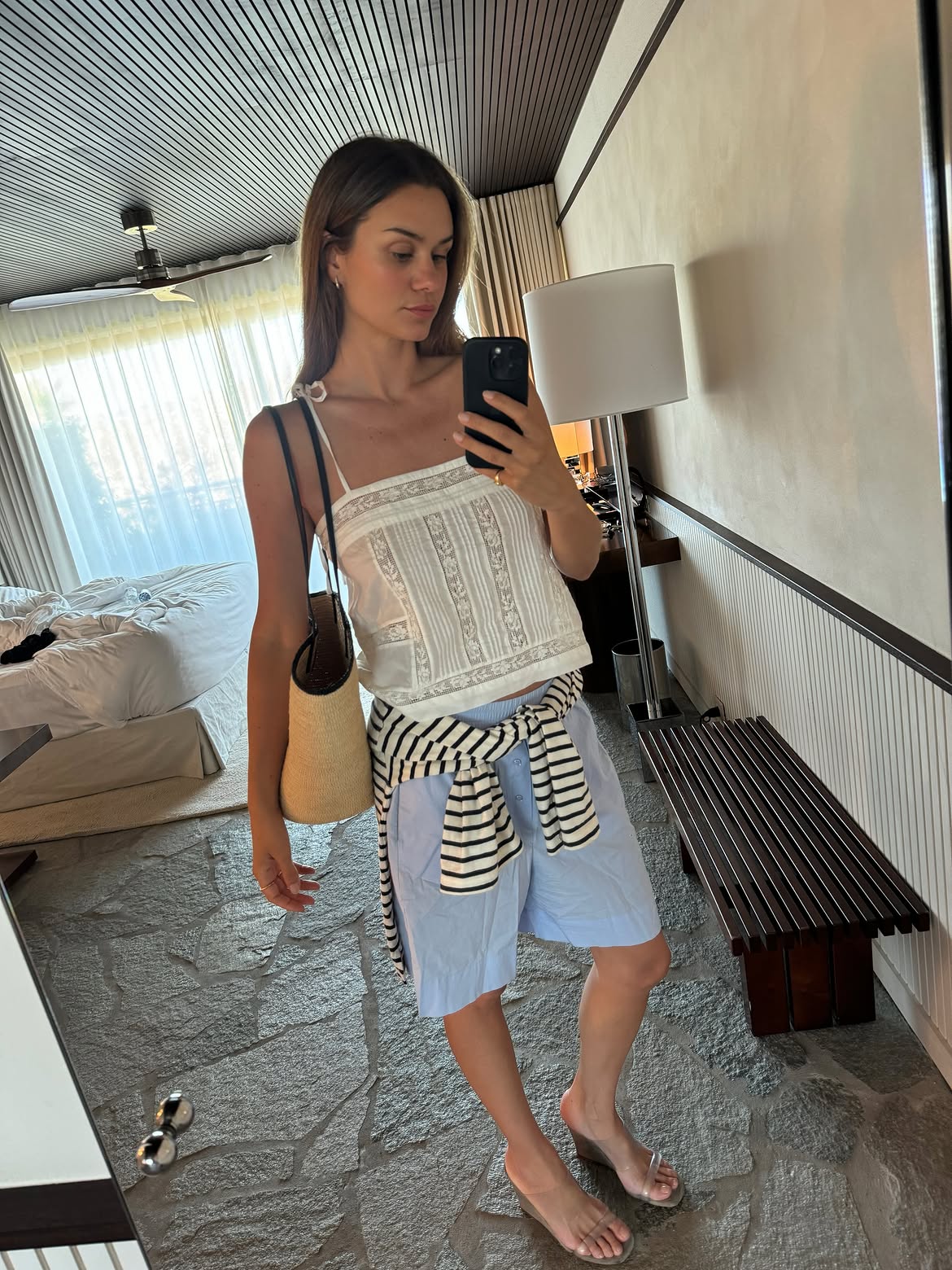 Anne-Laure Mais in a white tank and long shorts