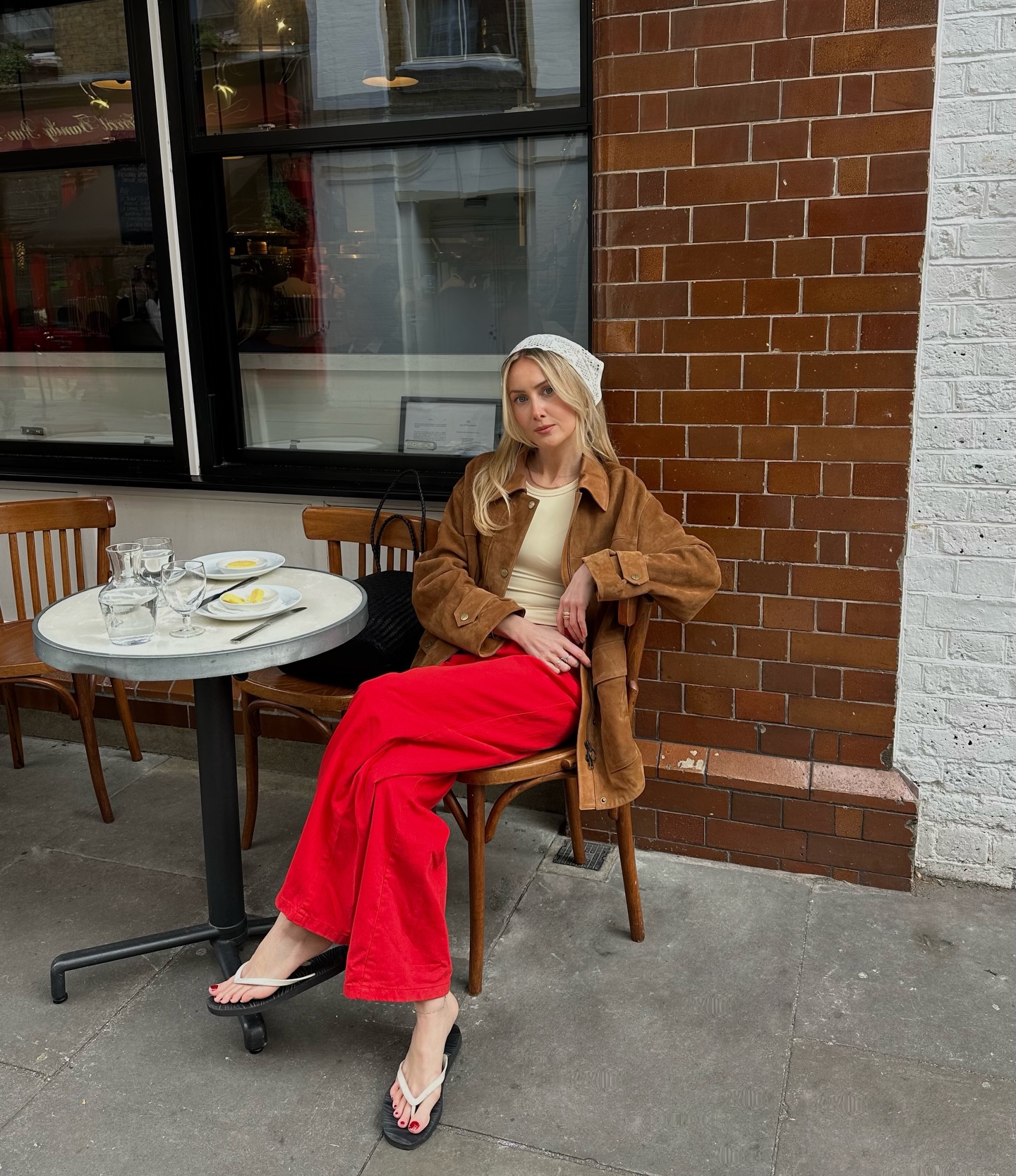 An image of @chloekathbutler wearing white shoes with red jeans
