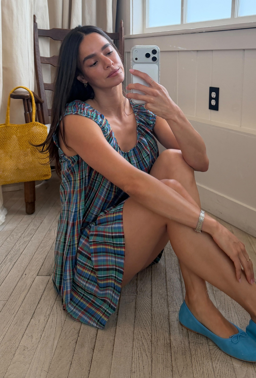 An image of @c.joanna wearing the checked fashion trend, as seen on the Doen Faye dress.