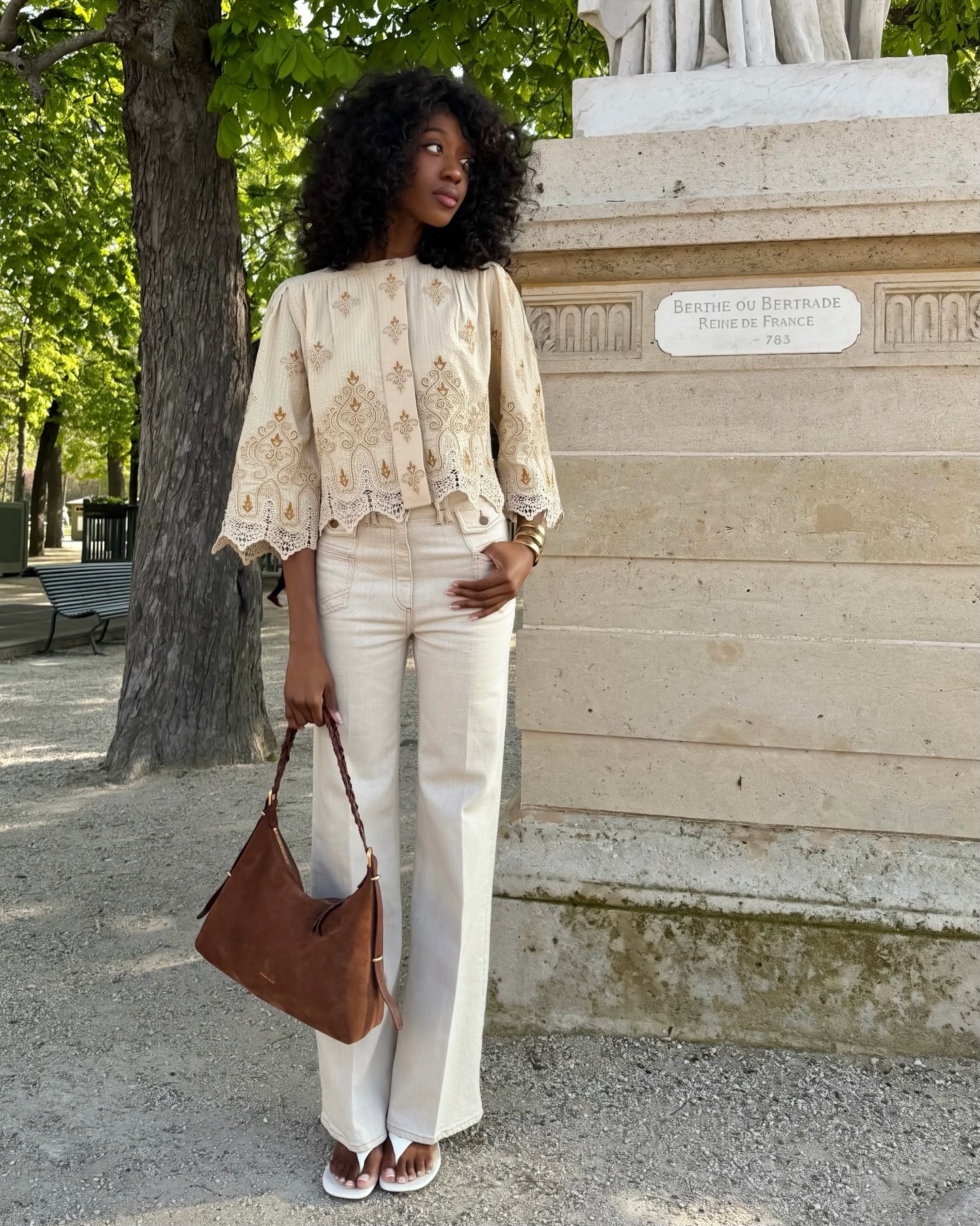 Emmanuelle in a crochet blouse and white jeans