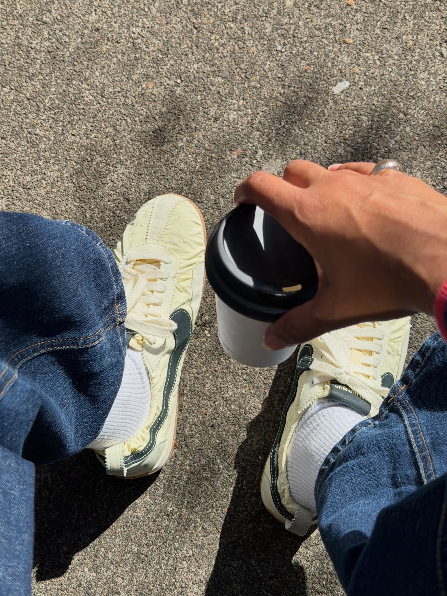 Claire Most wears Jacquemus + Nike sneakers.