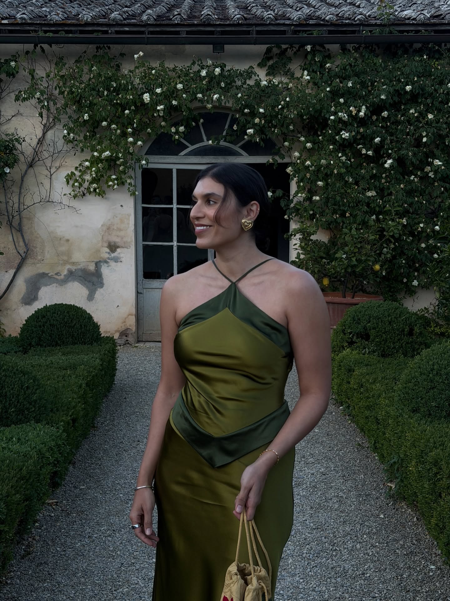 India in an olive green dress