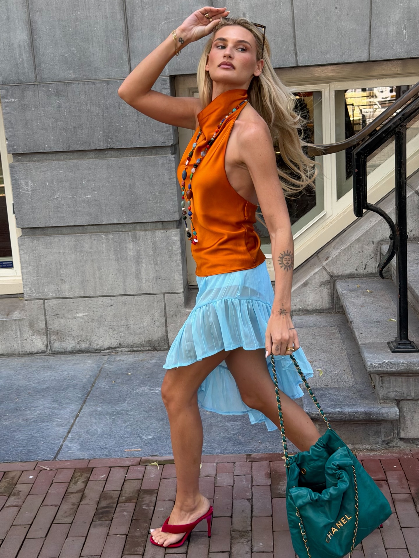 An image of a woman wearing asymmetric skirt outfit summer 2026