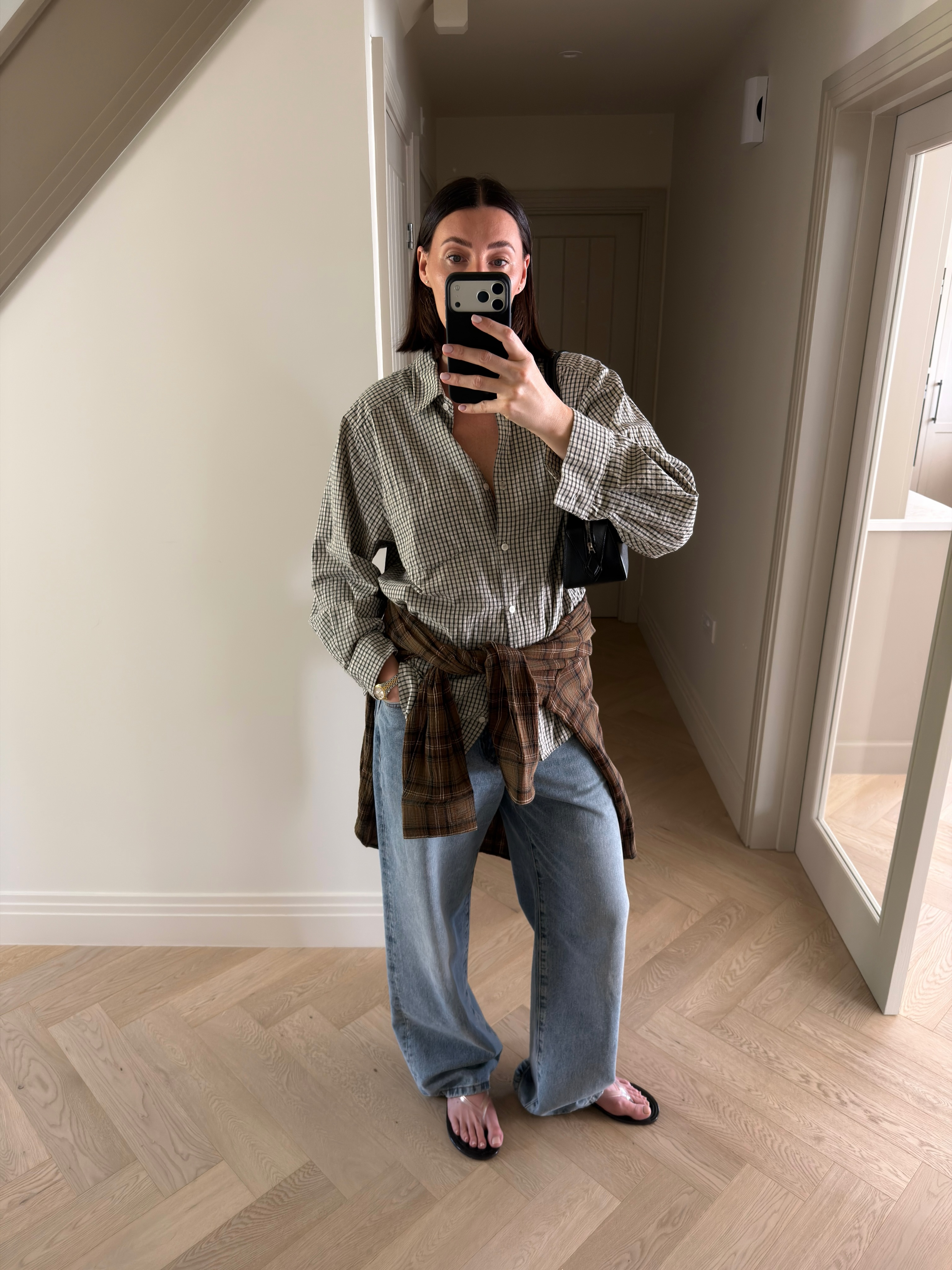 An image of a woman wearing summer to fall transitional denim outfit idea 2026