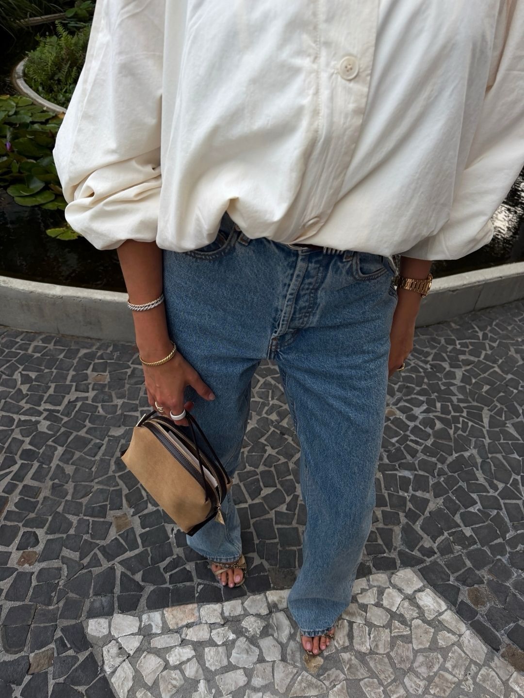 An image of a woman wearing summer to fall transitional denim outfit idea 2026