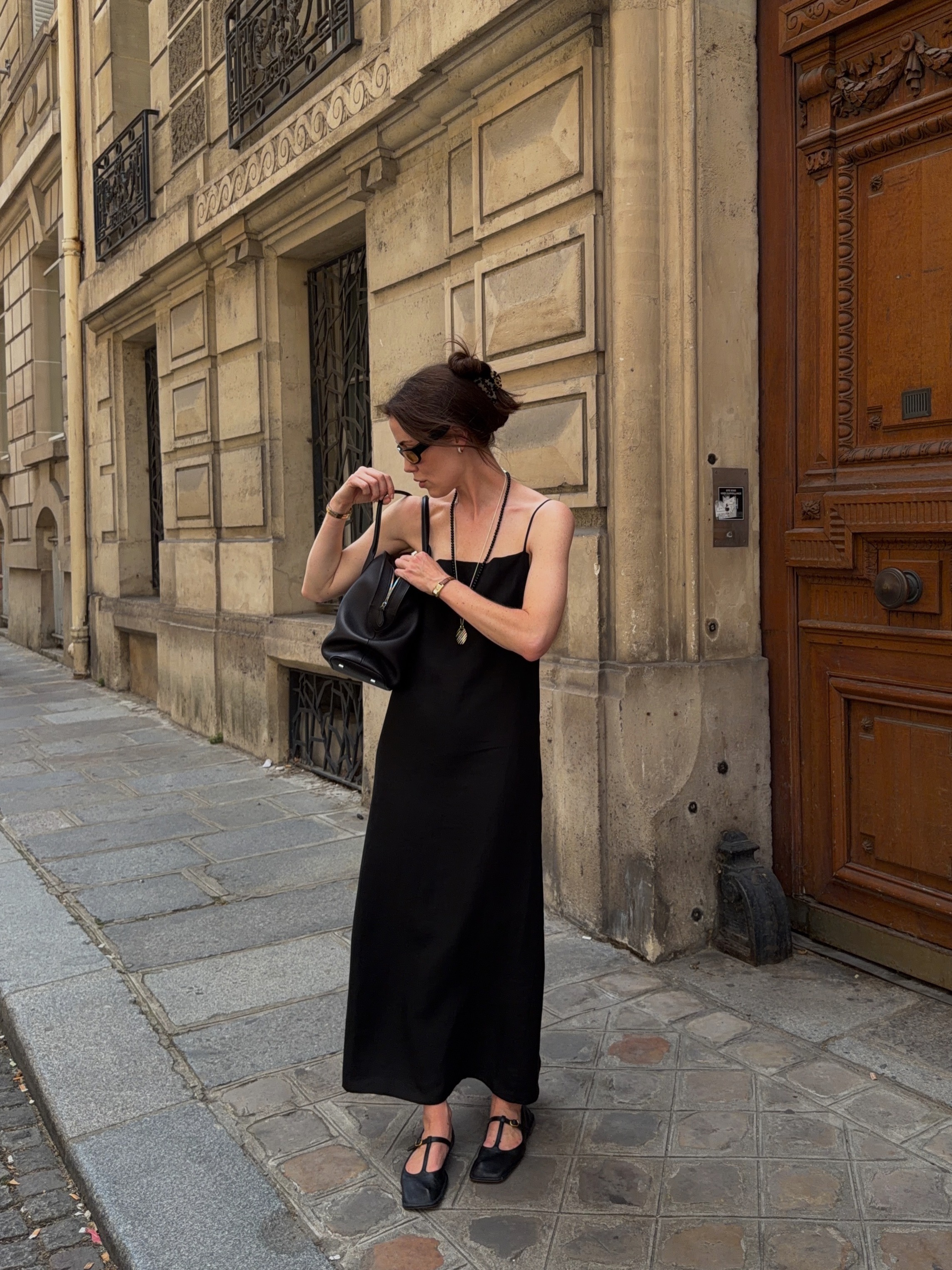 Woman wears black dress, black shoes