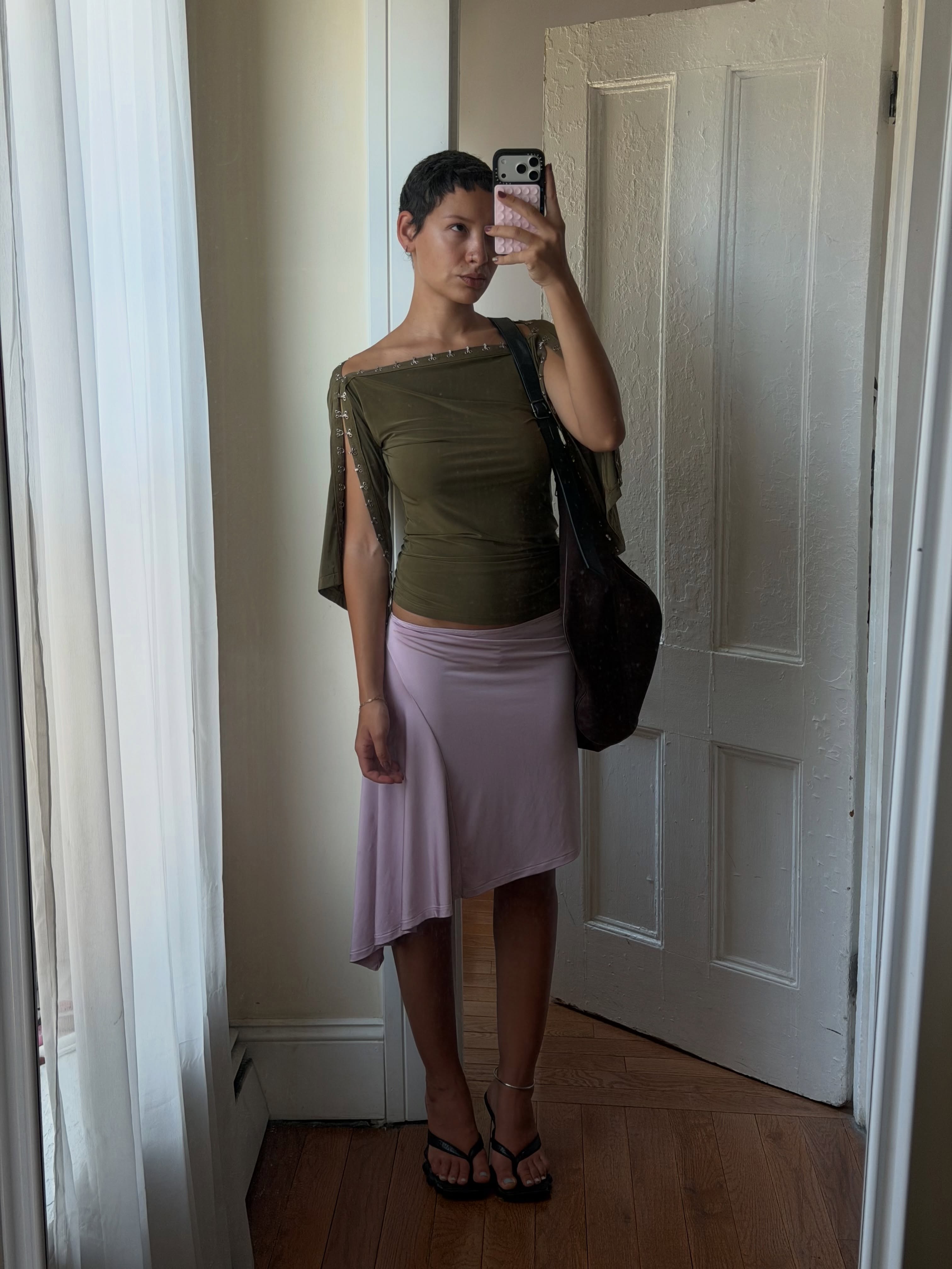 An image of a woman wearing asymmetric skirt outfit summer 2026