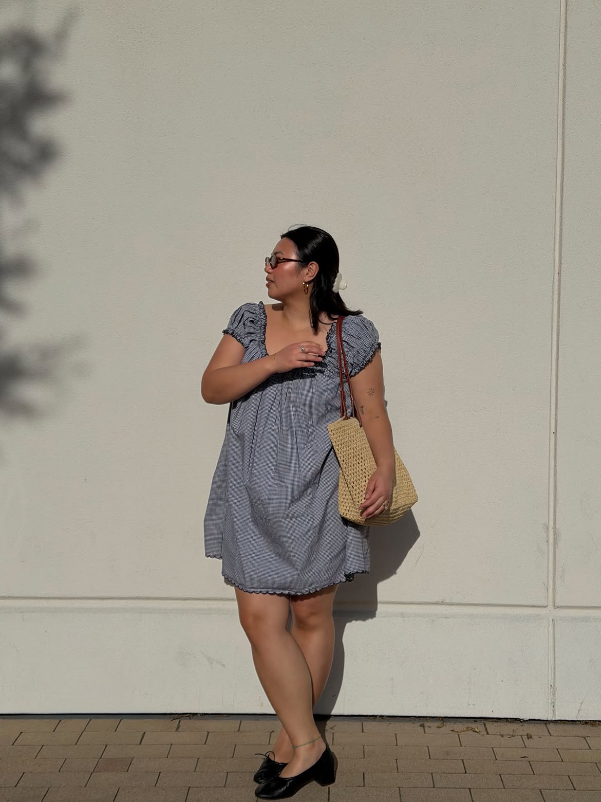 Marina wearing straw bag