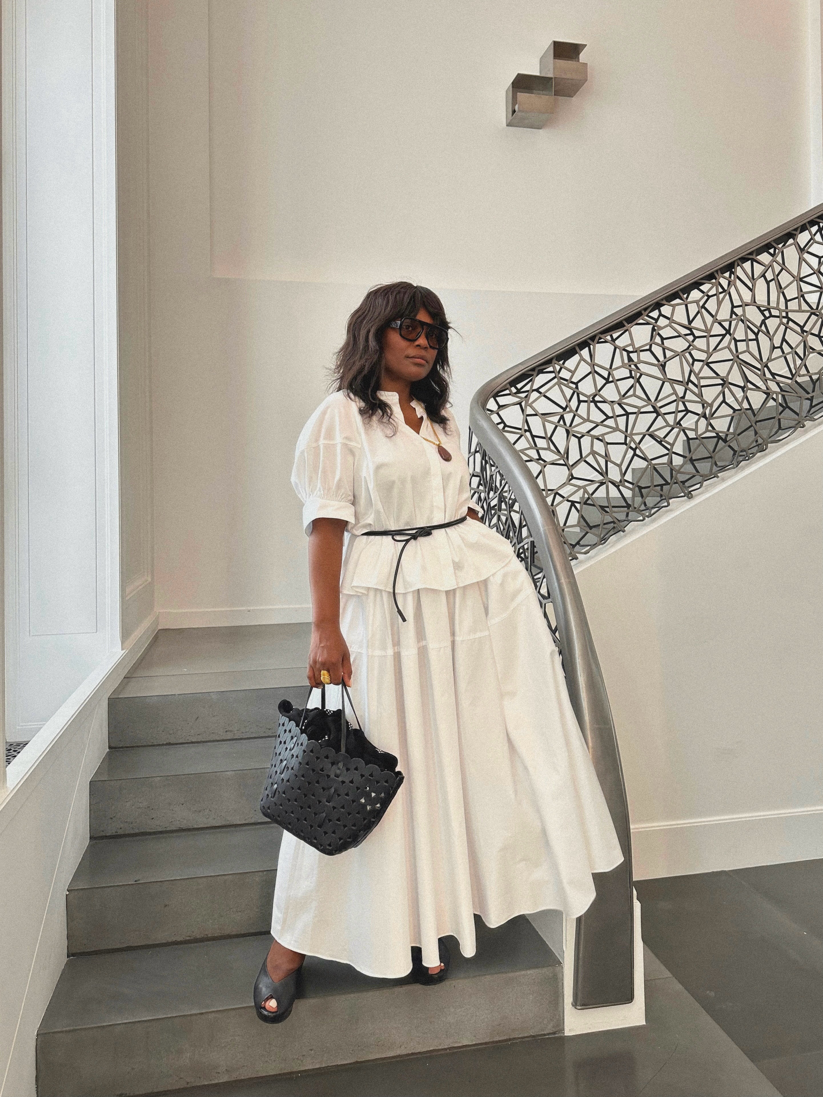 French woman wearing a stylish summer outfit.