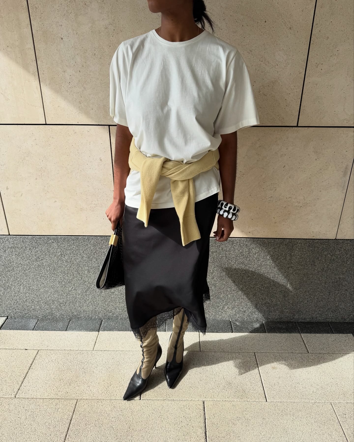 @nlmarilyn wearing a T-shirt, a lace-trim knee-length skirt, and knee-high boots.