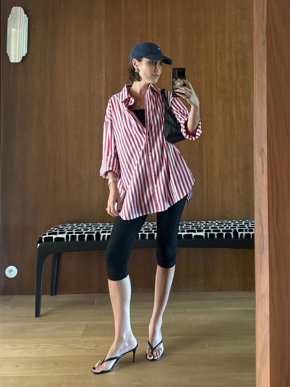 Erin Off Duty wearing a striped button-down shirt with Capri pants and heeled thongs