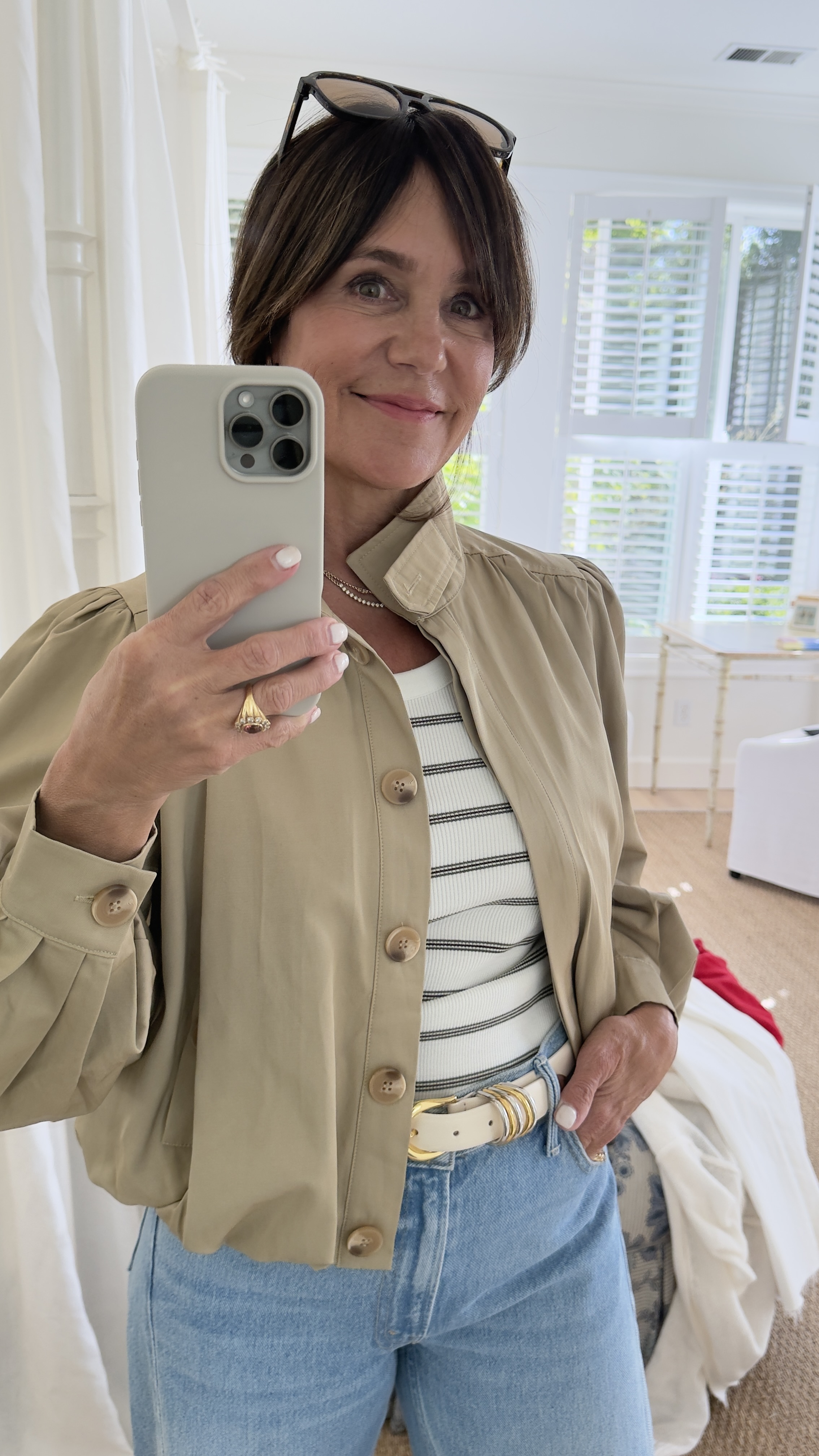 Susie Wright wearing a striped tee, light jeans, and a tan blouson jacket.