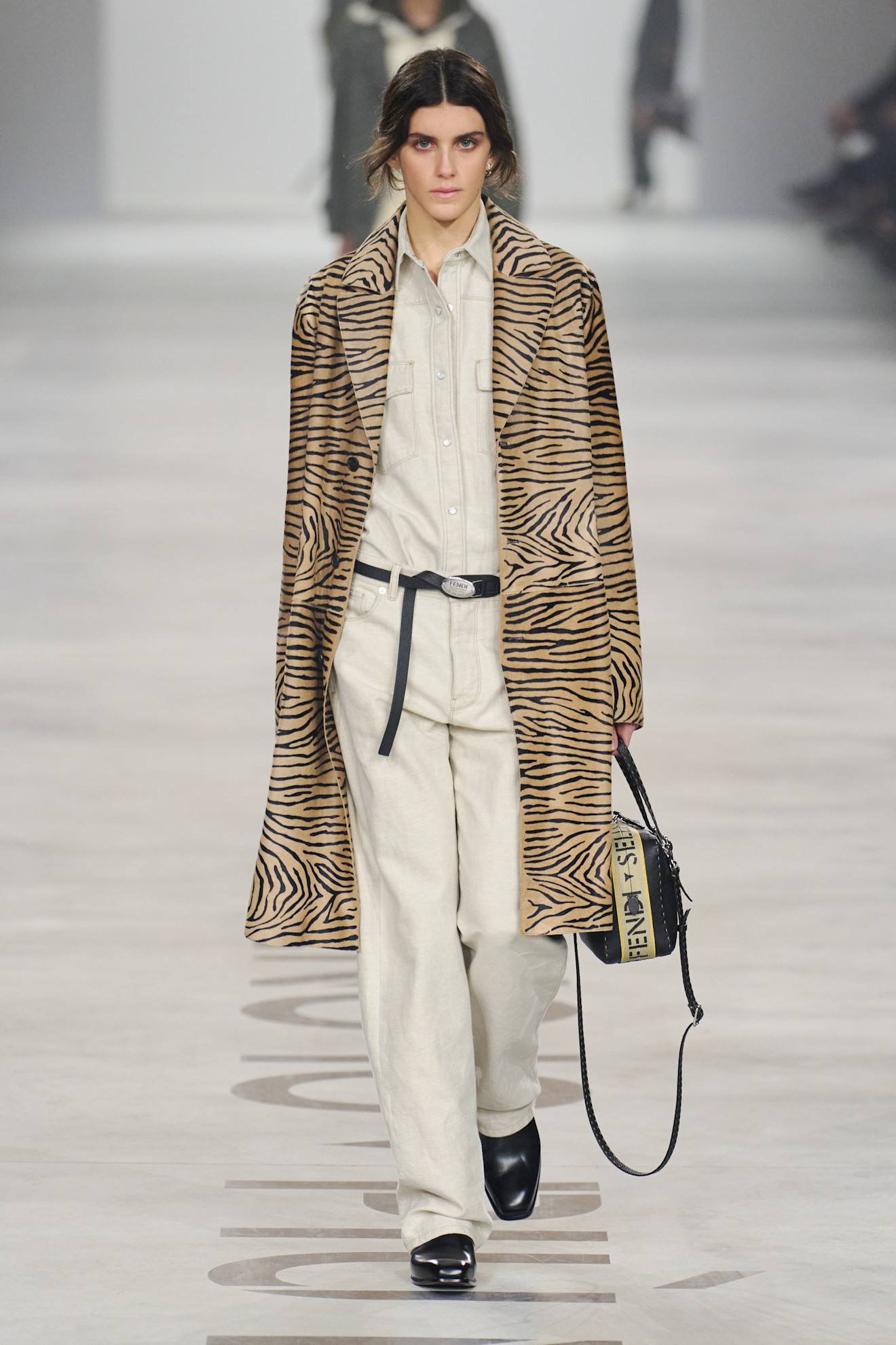 Woman in animal print coat on the Fendi runway.
