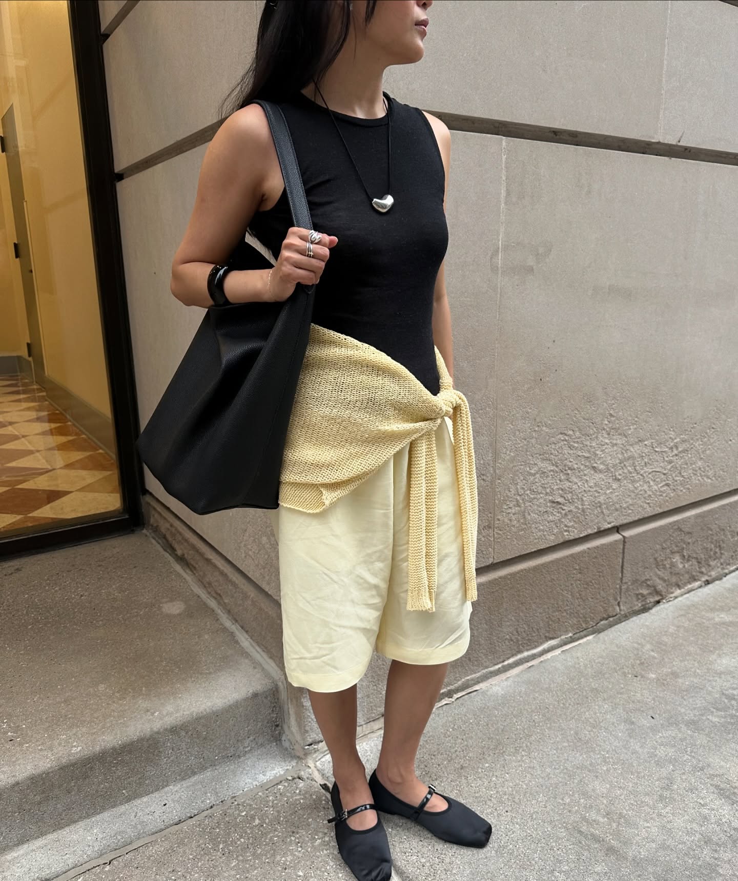 Dawn in black vest and yellow Bermudas