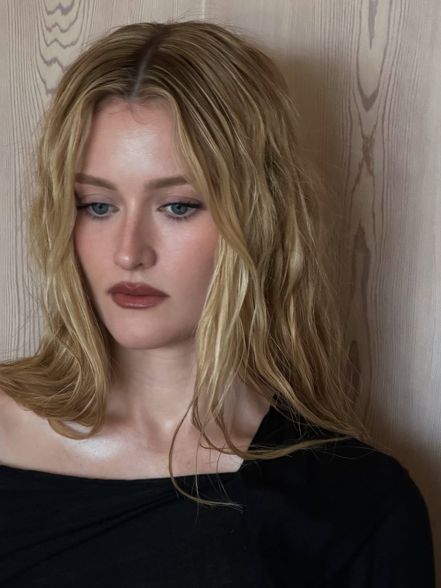 A woman with long wavy blonde hair