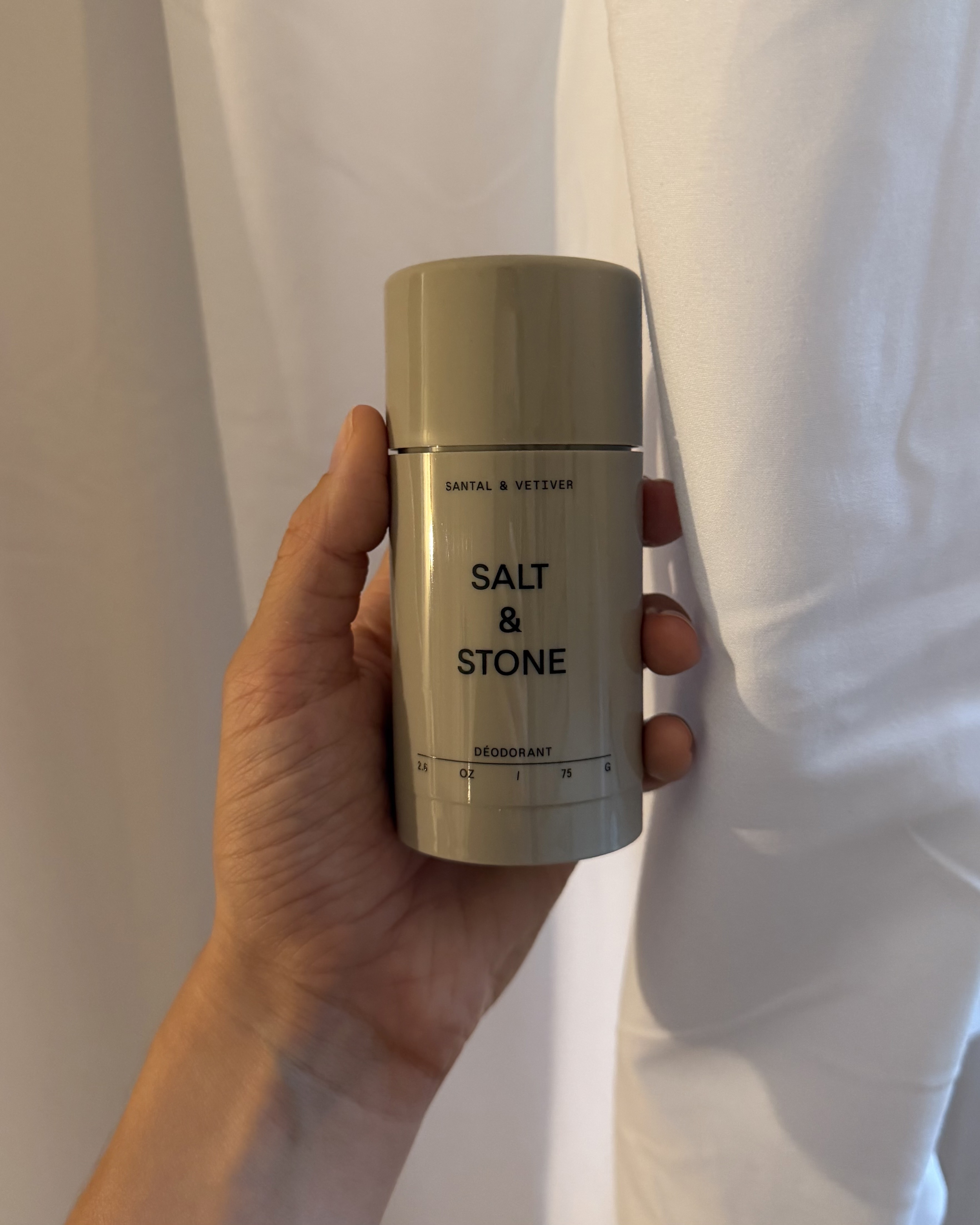 An image of associate beauty editor Alyssa Brascia holding the Salt & Stone Santal & Vetiver Extra-Strength Aluminum-Free Deodorant.