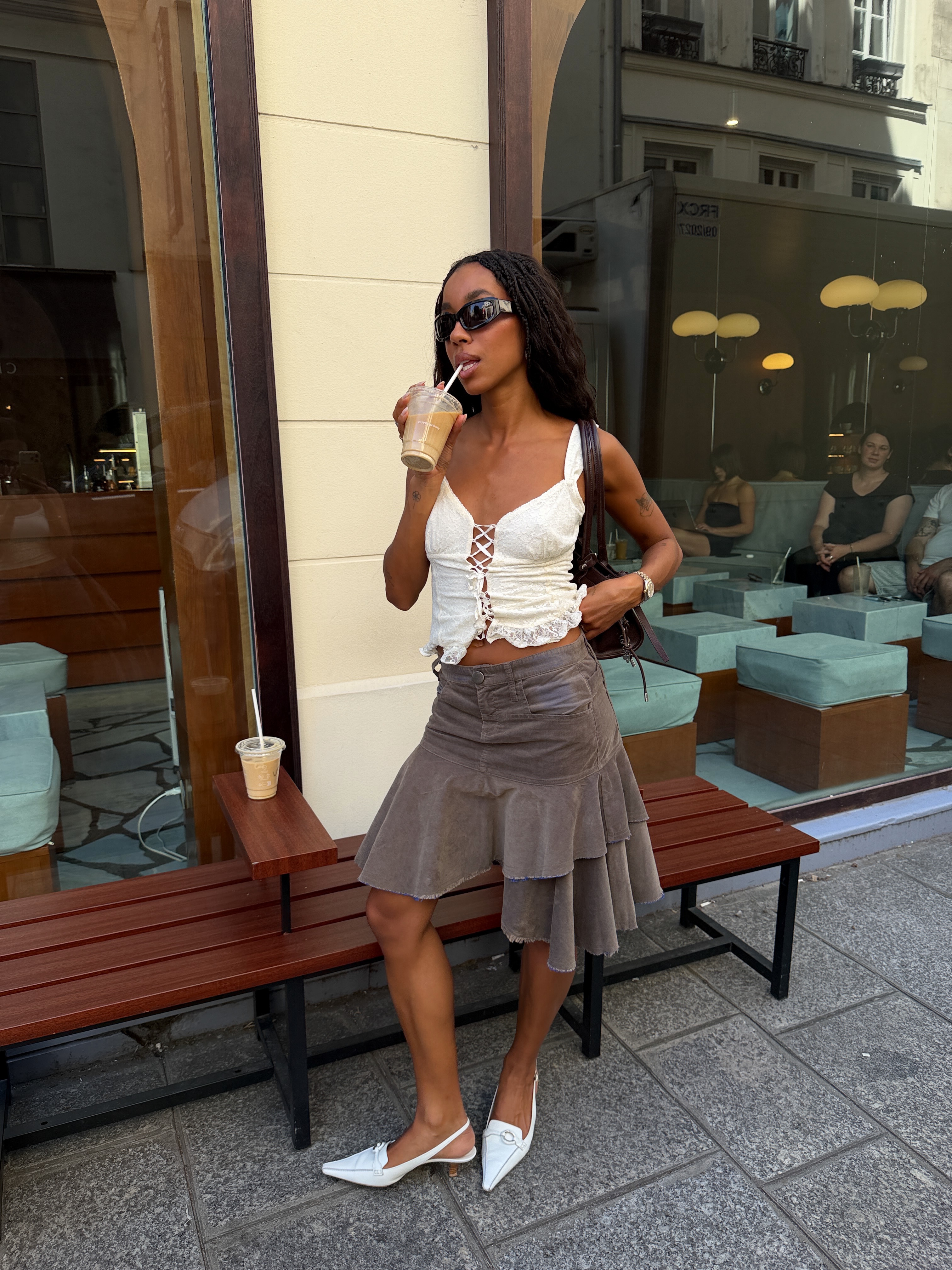 An image of a woman wearing asymmetric skirt outfit summer 2026