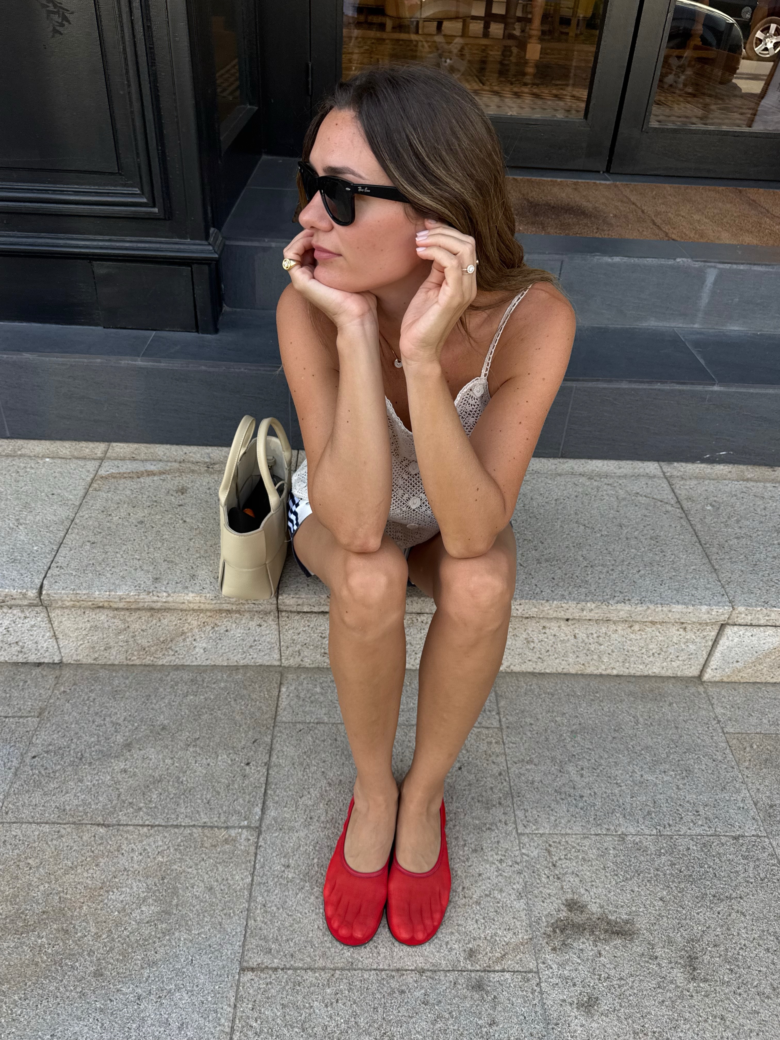 Anne-Laure Mais wearing red mesh flats.