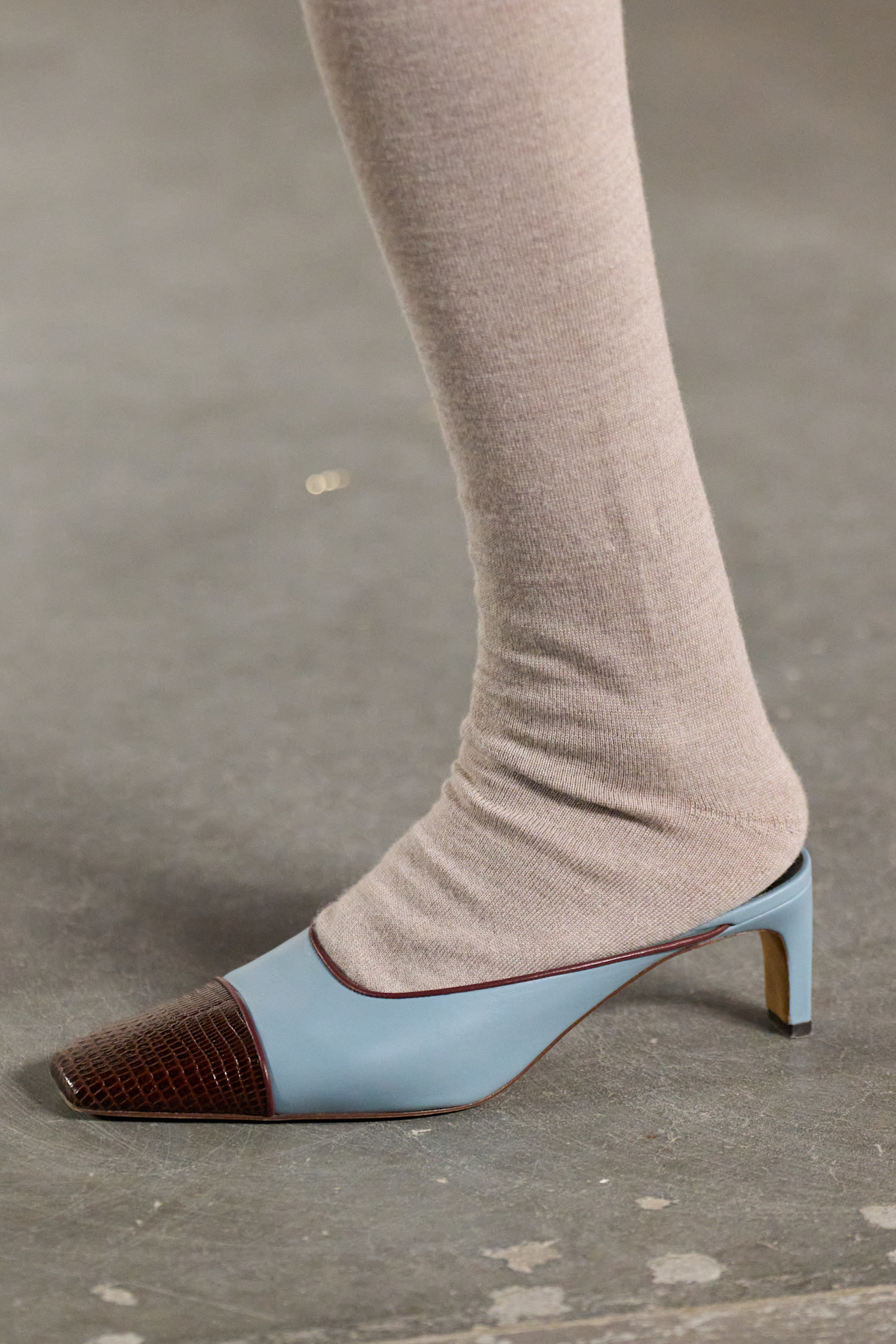 Woman in two-toned shoes.