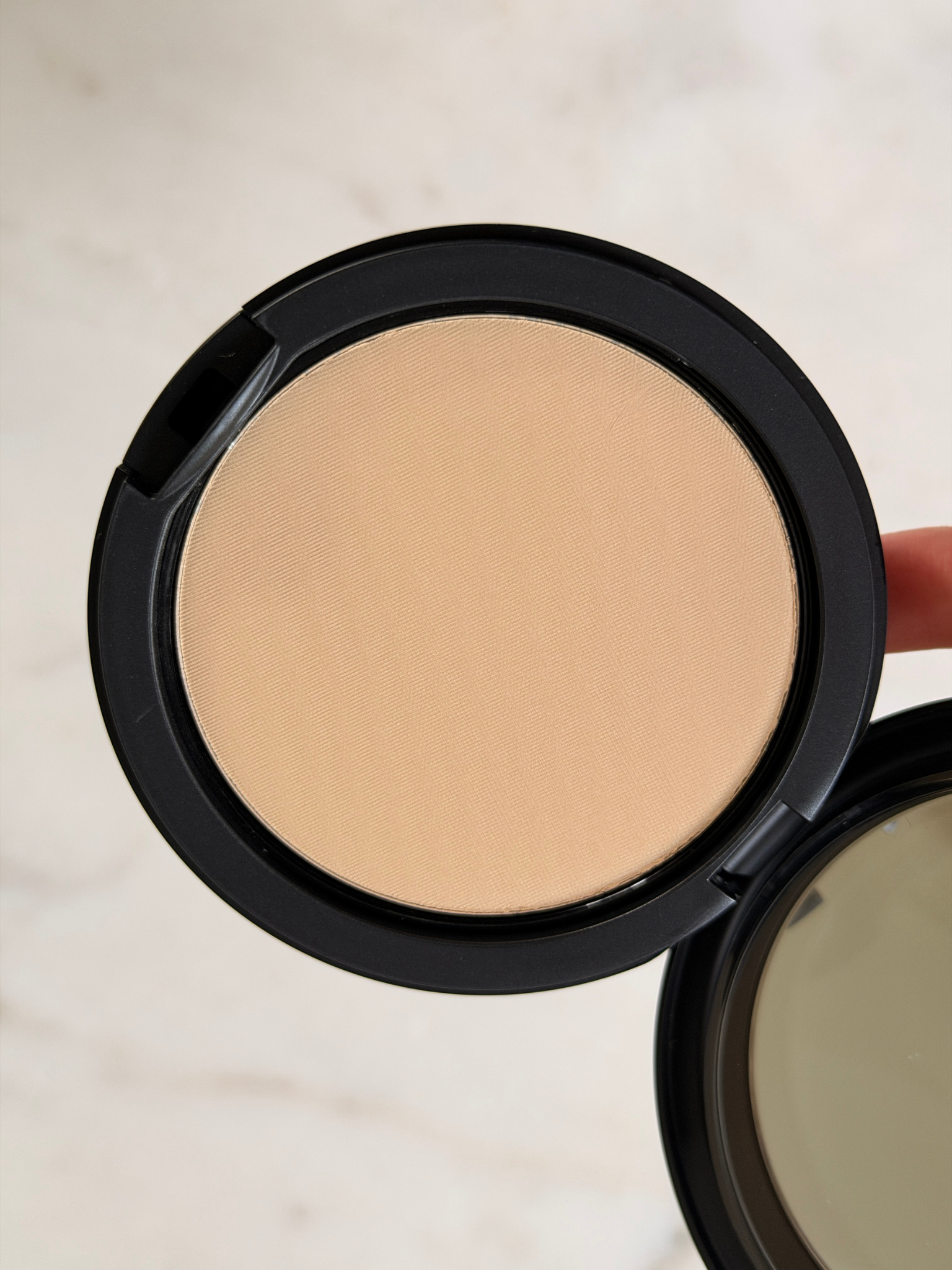 Grace Day holding the MAC powder foundation