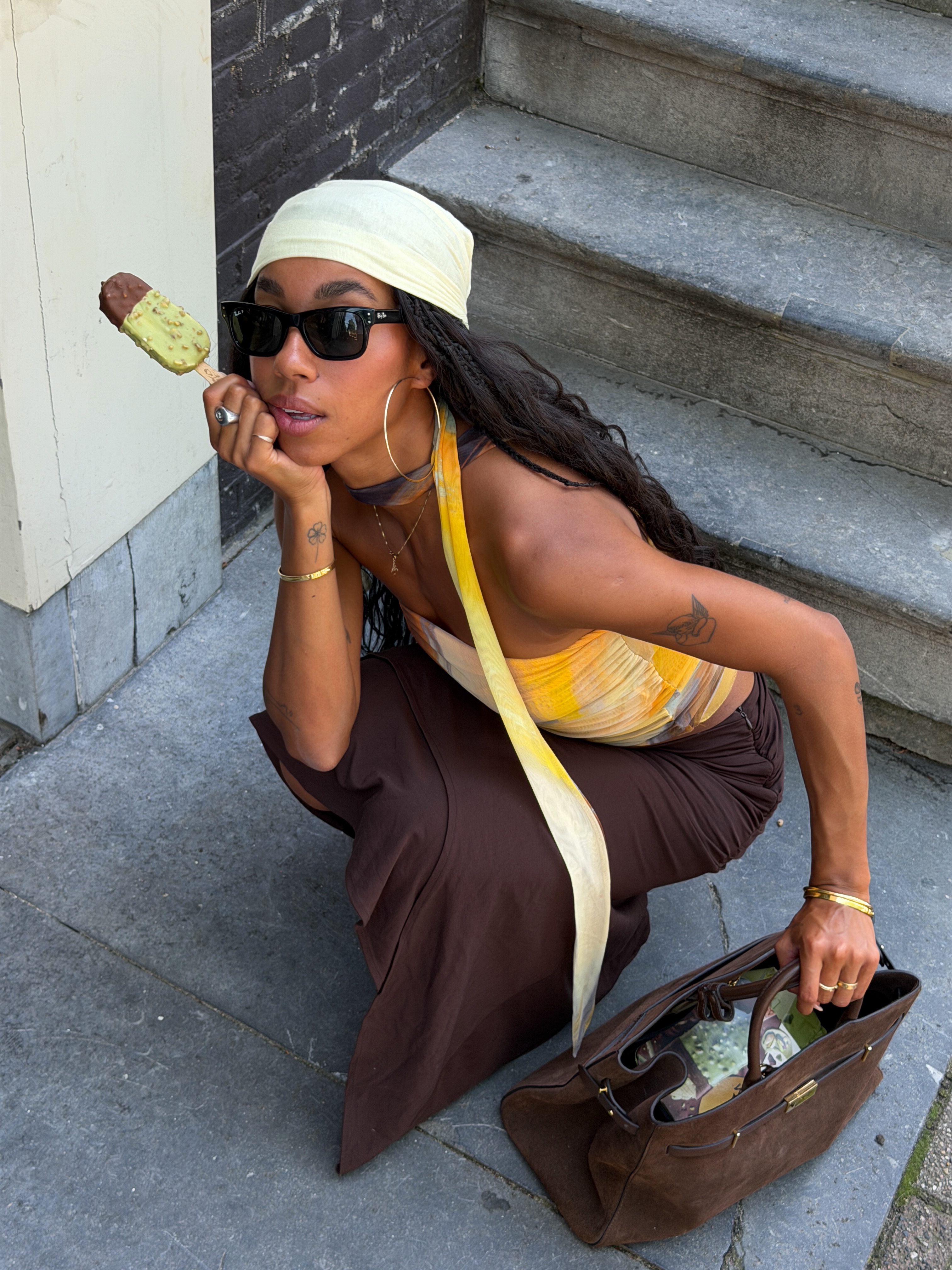 Photo of a woman wearing a hair scarf eating ice cream