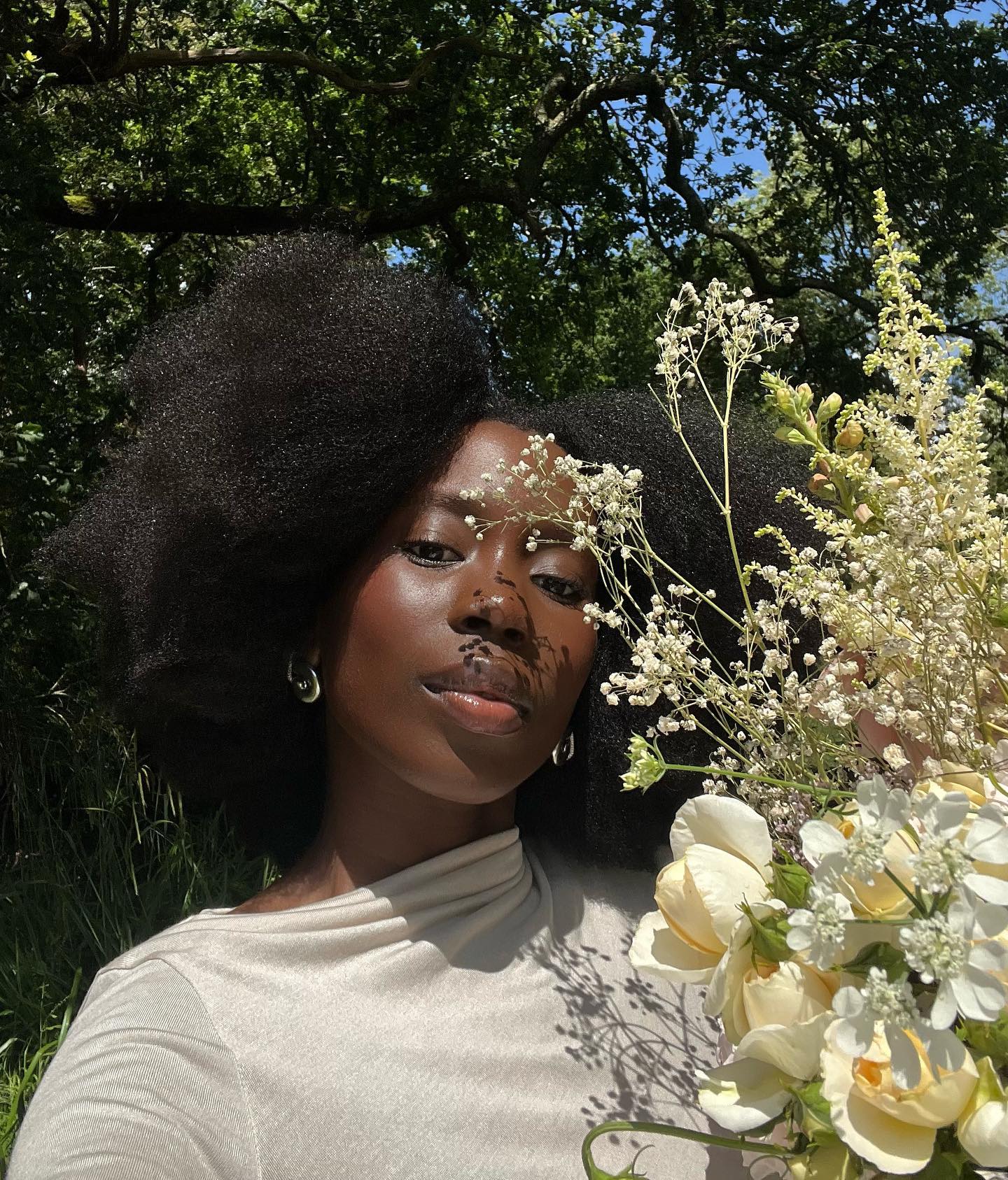 A selfie of @daniellejinadu with white flowers