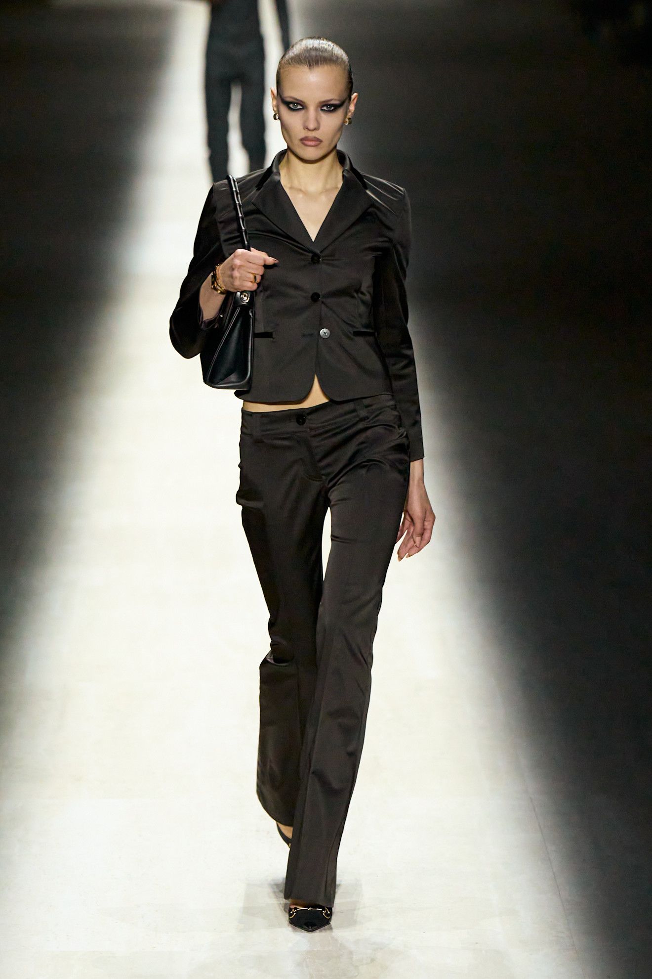 Woman in a fitted blazer and pants.