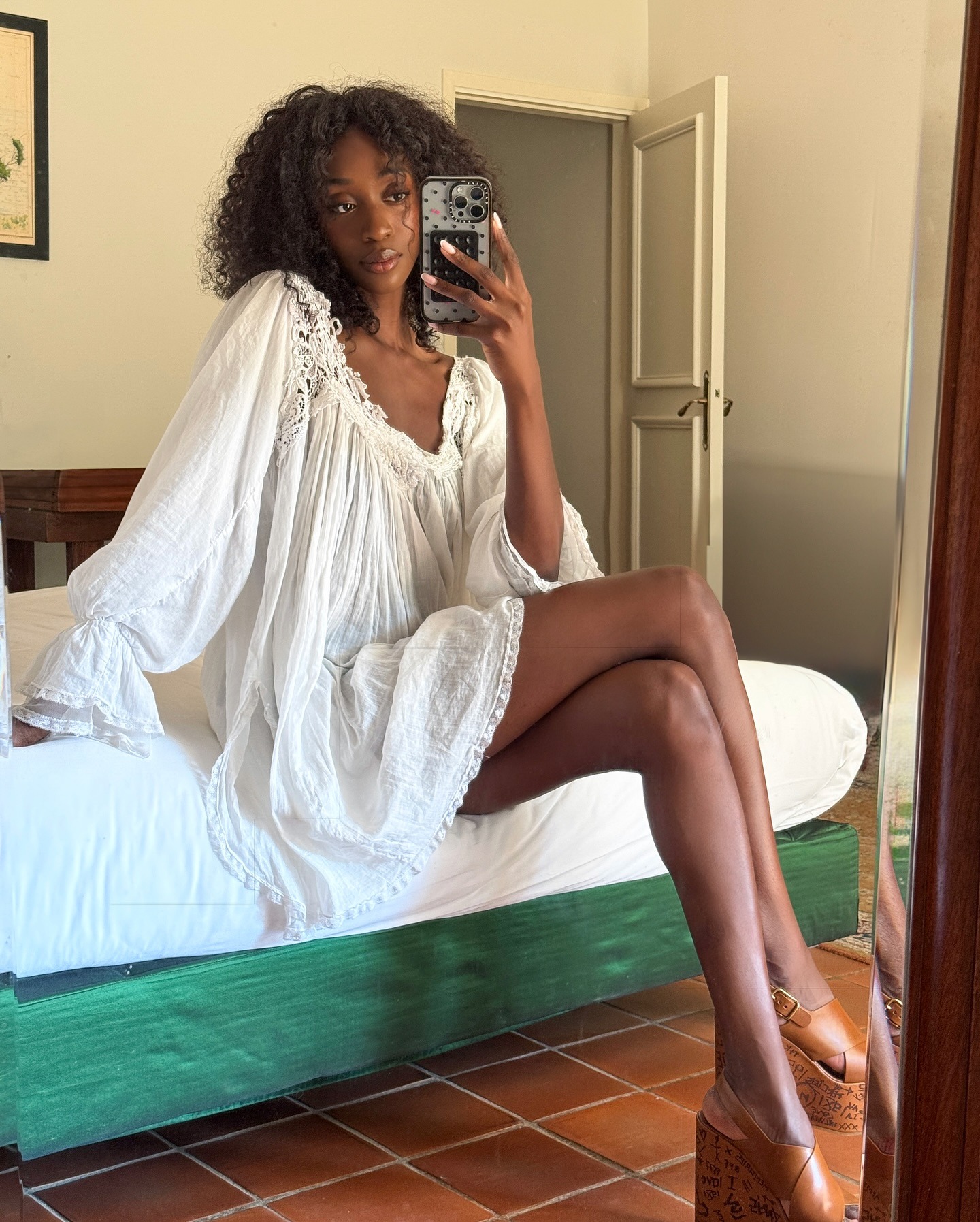 Woman wears white mini dress, brown leather platform heels