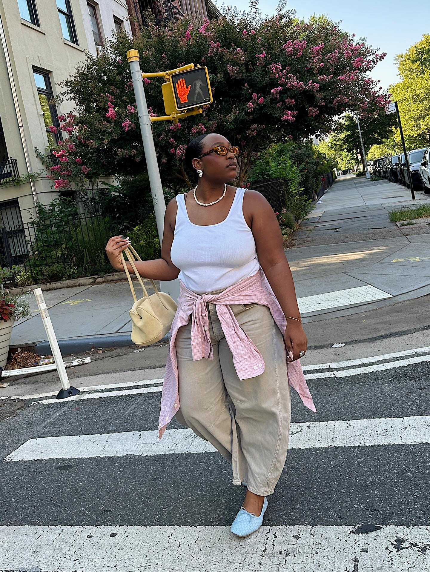 Aniyah in barrel trousers and white vest