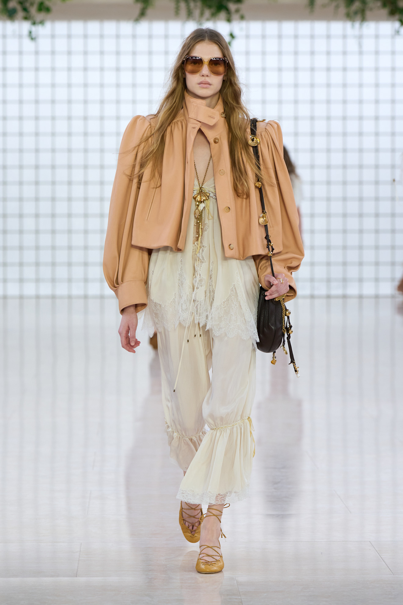 Model walks the Chloe SS25 runway wearing bloomer trousers and Ghillie flats.
