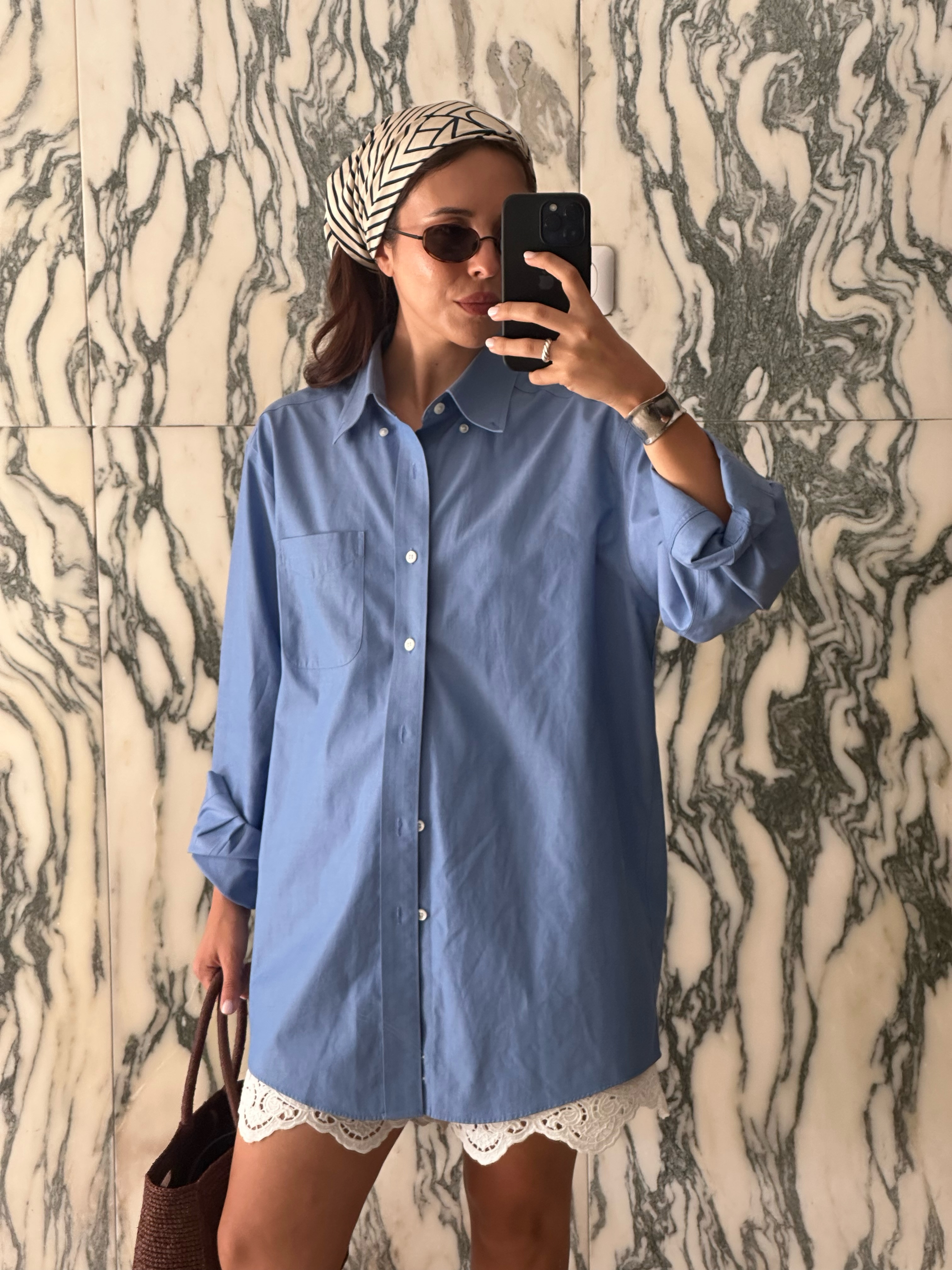 Débora in a blue button-down, lace shorts and silk scarf
