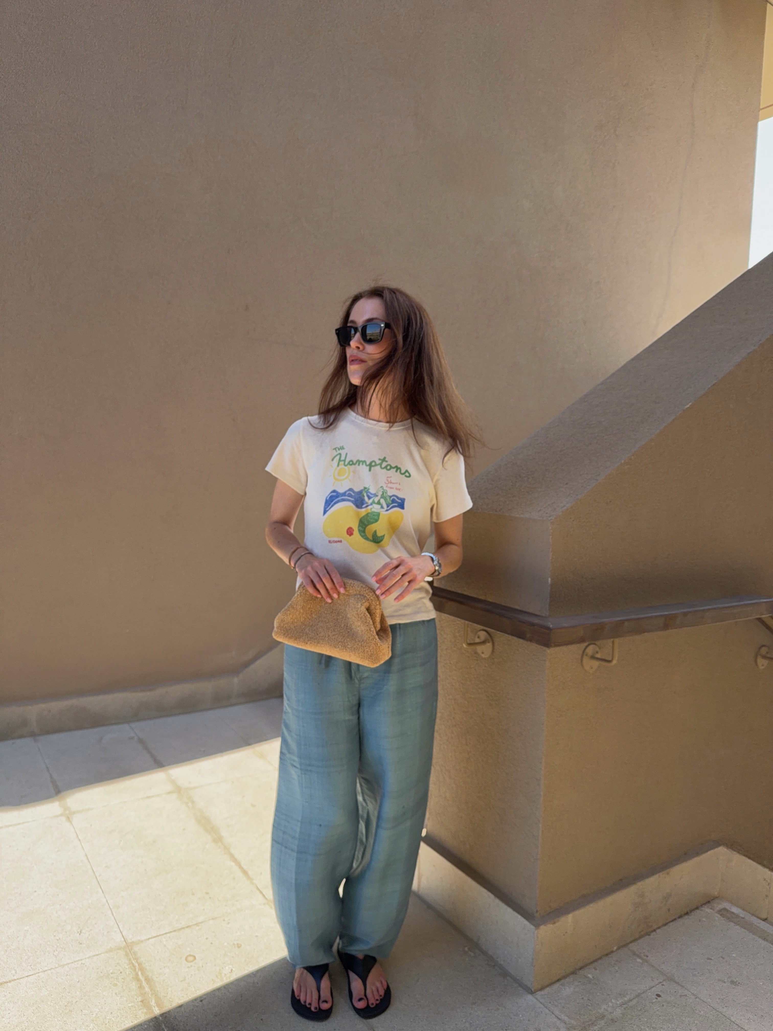 Influencer wearing a T-shirt, low-rise drawstring pants, and flip-flops