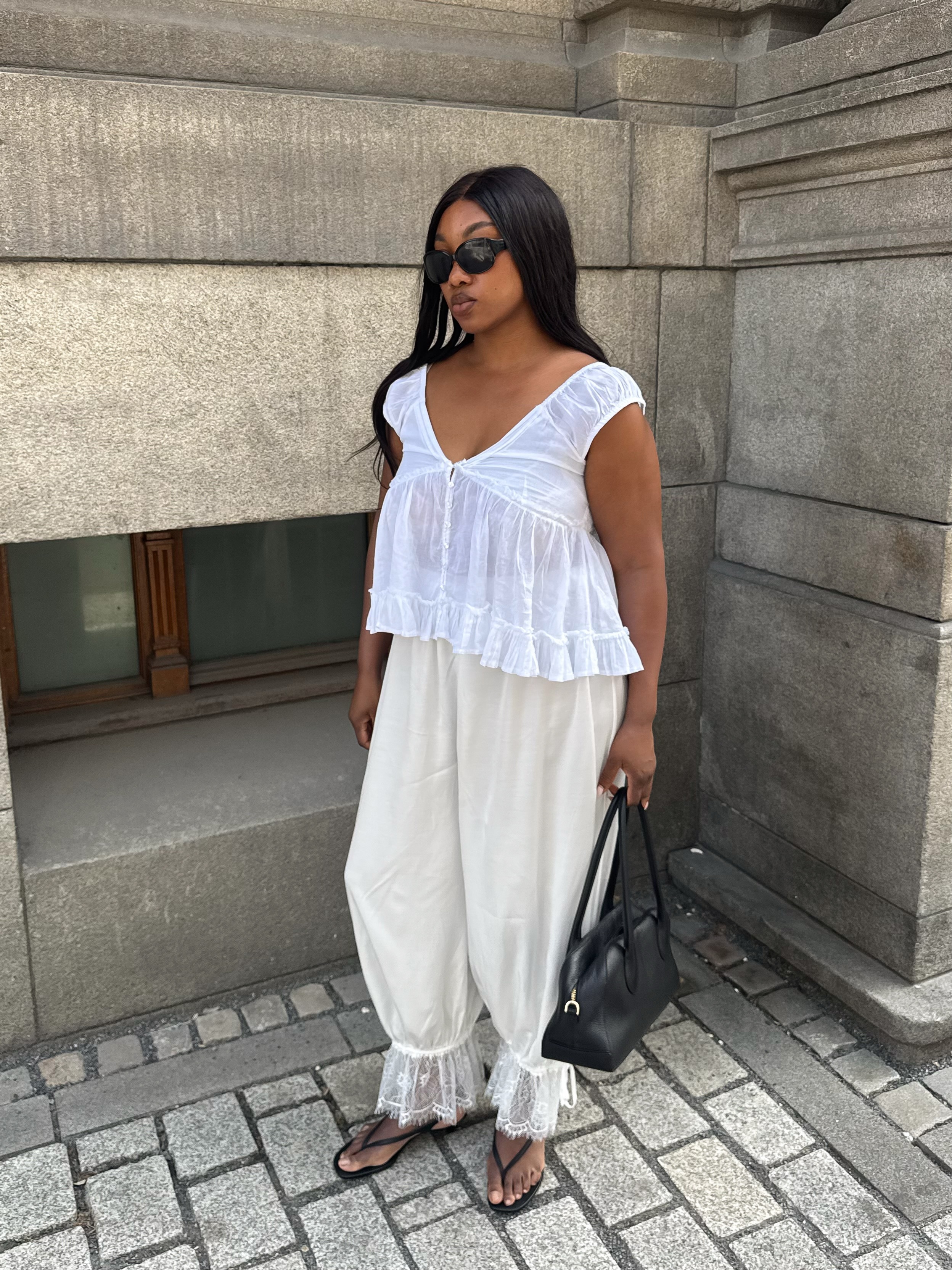 Nnenna Echem in white embroidered NA-KD balloon pants.