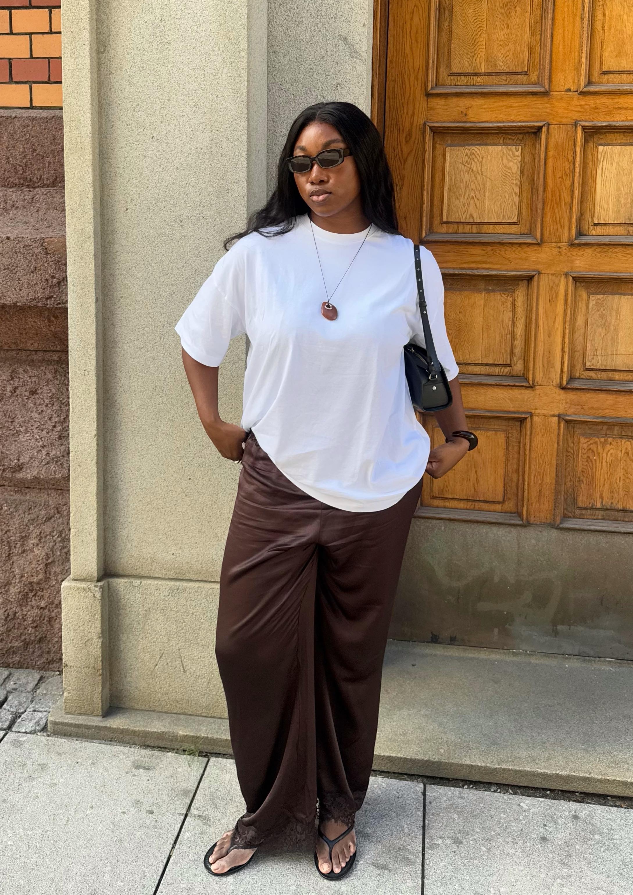 Nnenna wearing lace-trim trousers and a T-shirt