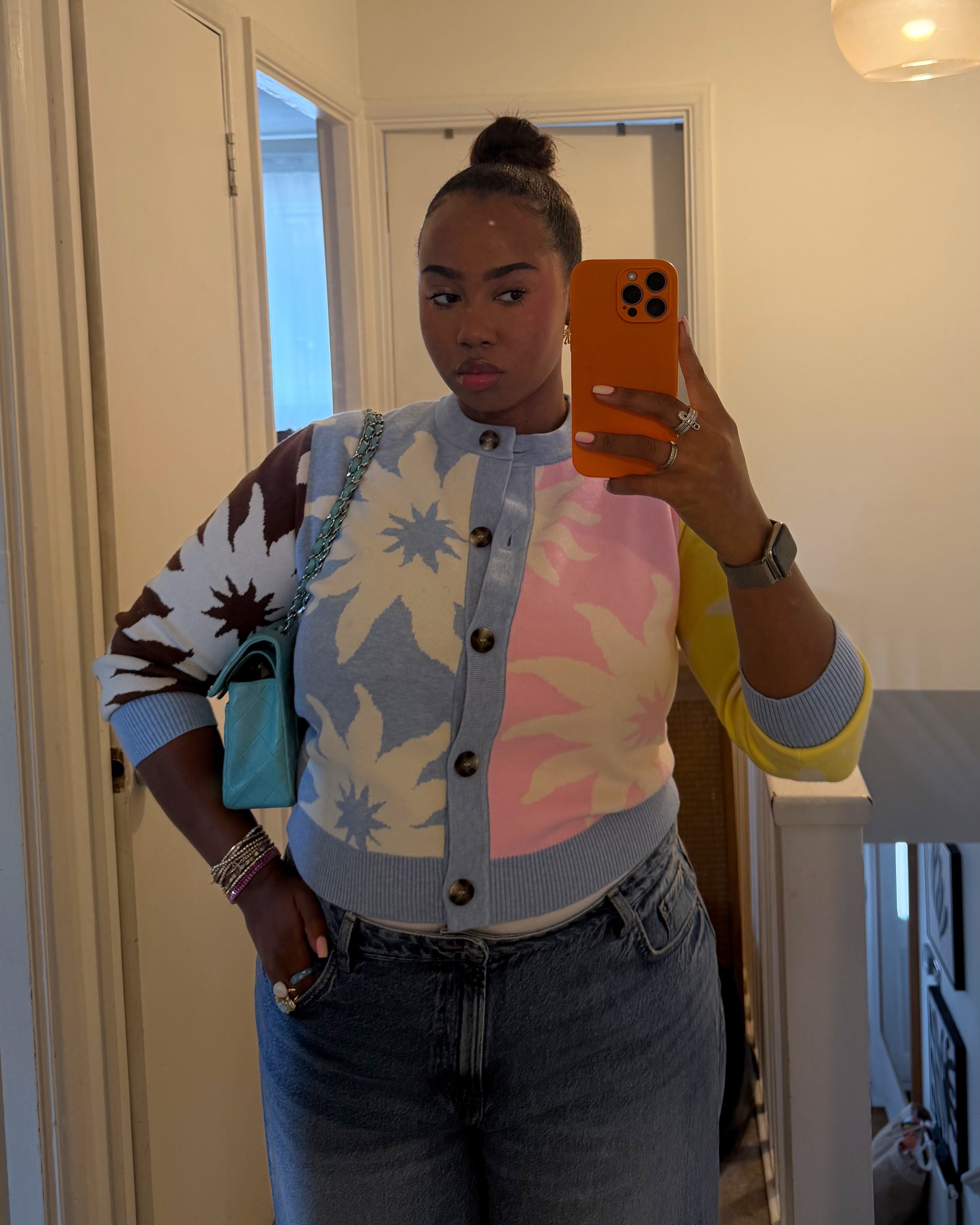 An image of a woman wearing summer to fall transitional denim outfit idea 2026