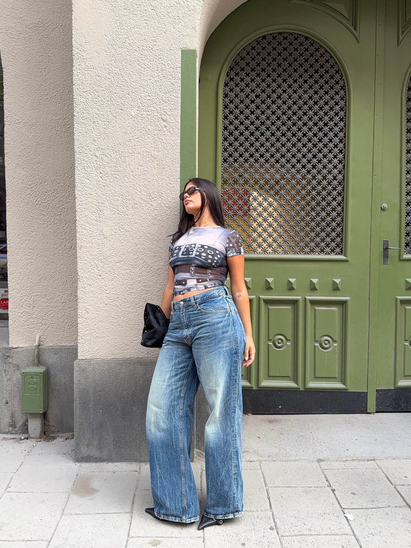 An image of a woman wearing summer to fall transitional denim outfit idea 2026