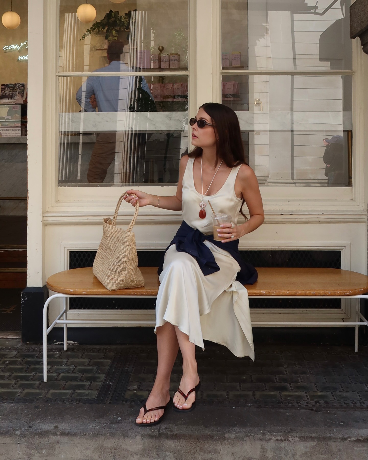 Woman wearing summer dress with flip-flops.
