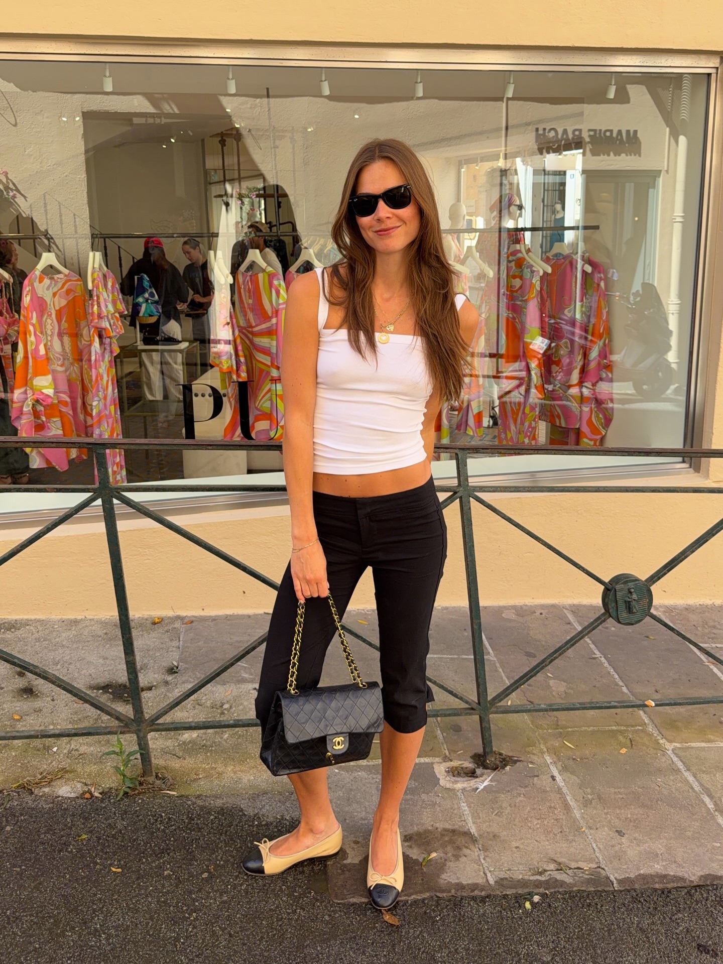 Woman in capri pants and a tank top.