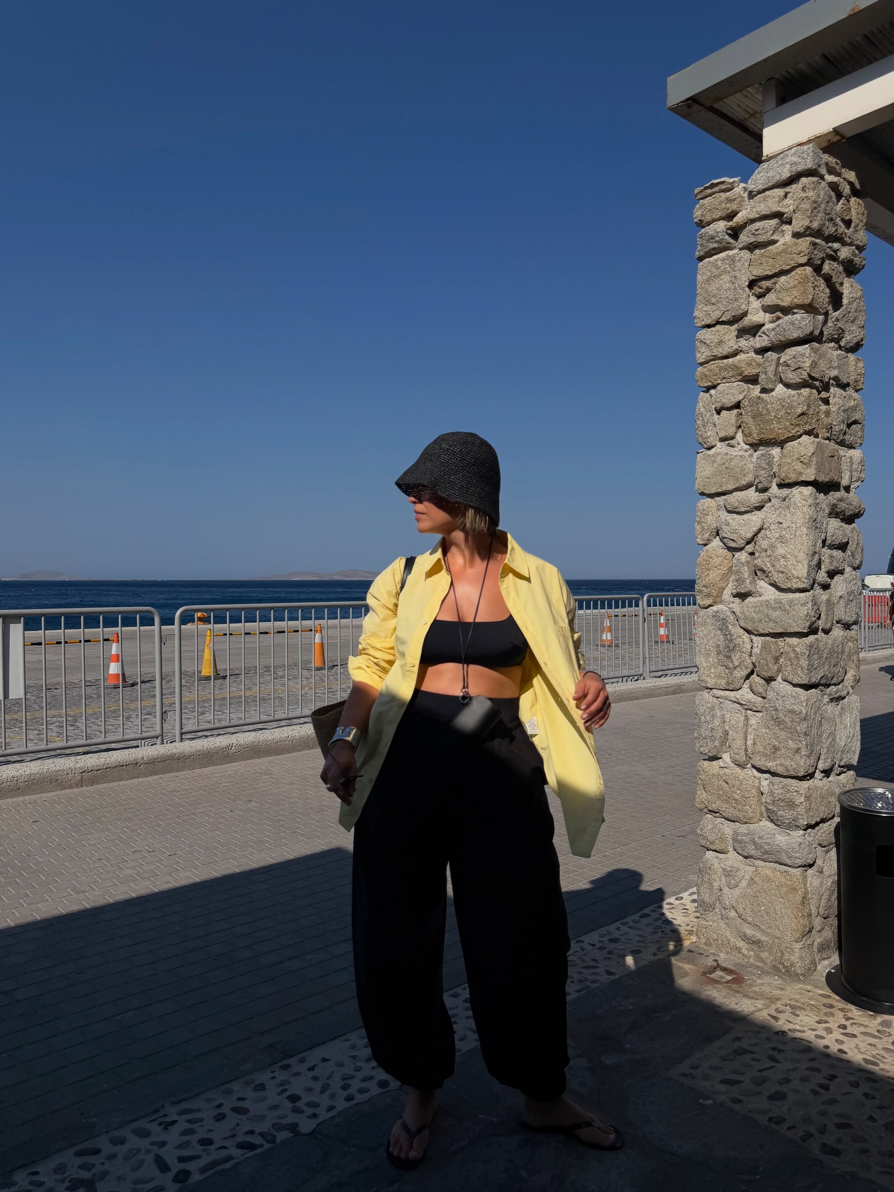 Influencer Alexis Foreman wearing an oversized shirt, scoop bralette and wide-leg trousers.