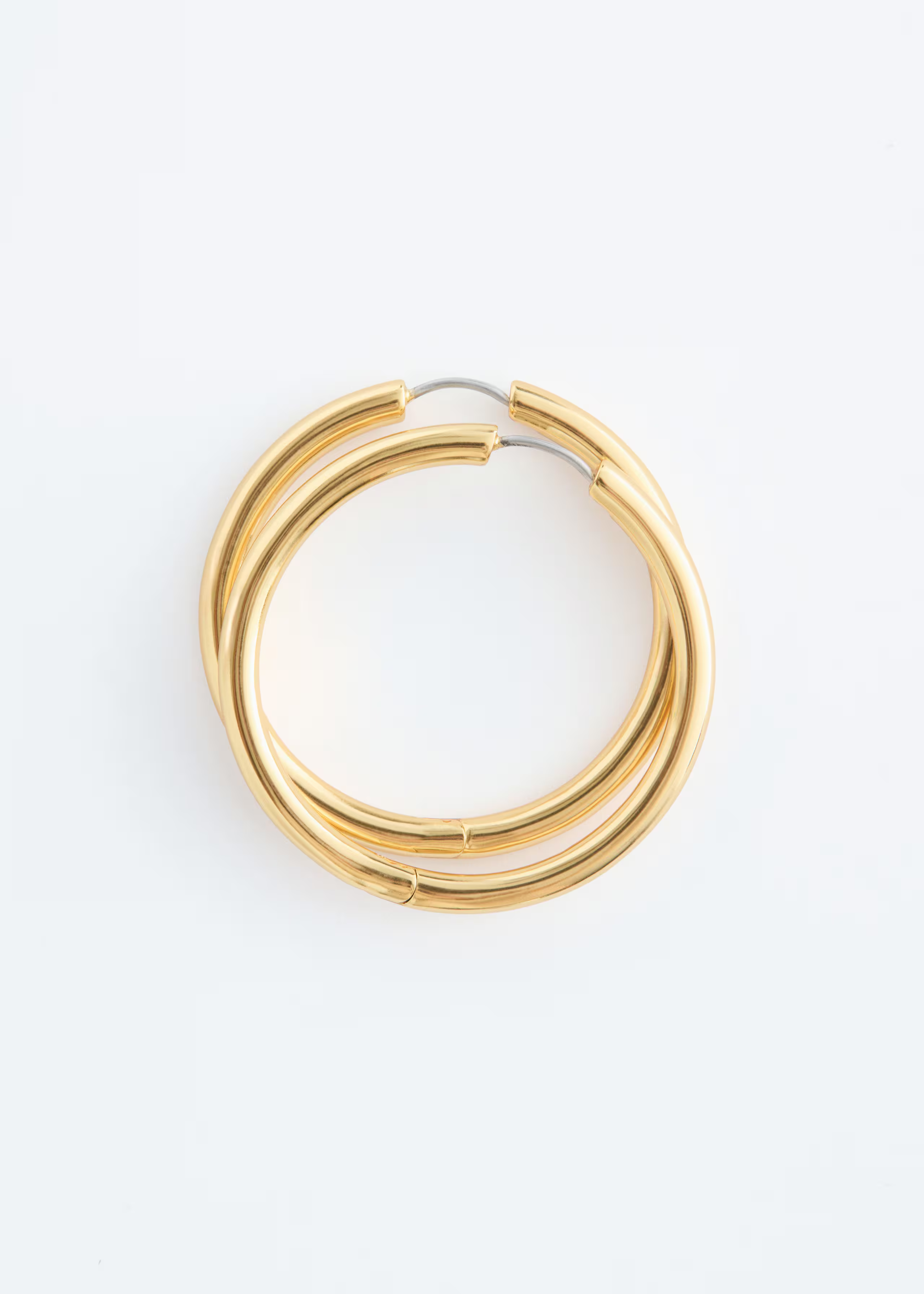 A pair of & other Stories gold hoop earrings.
