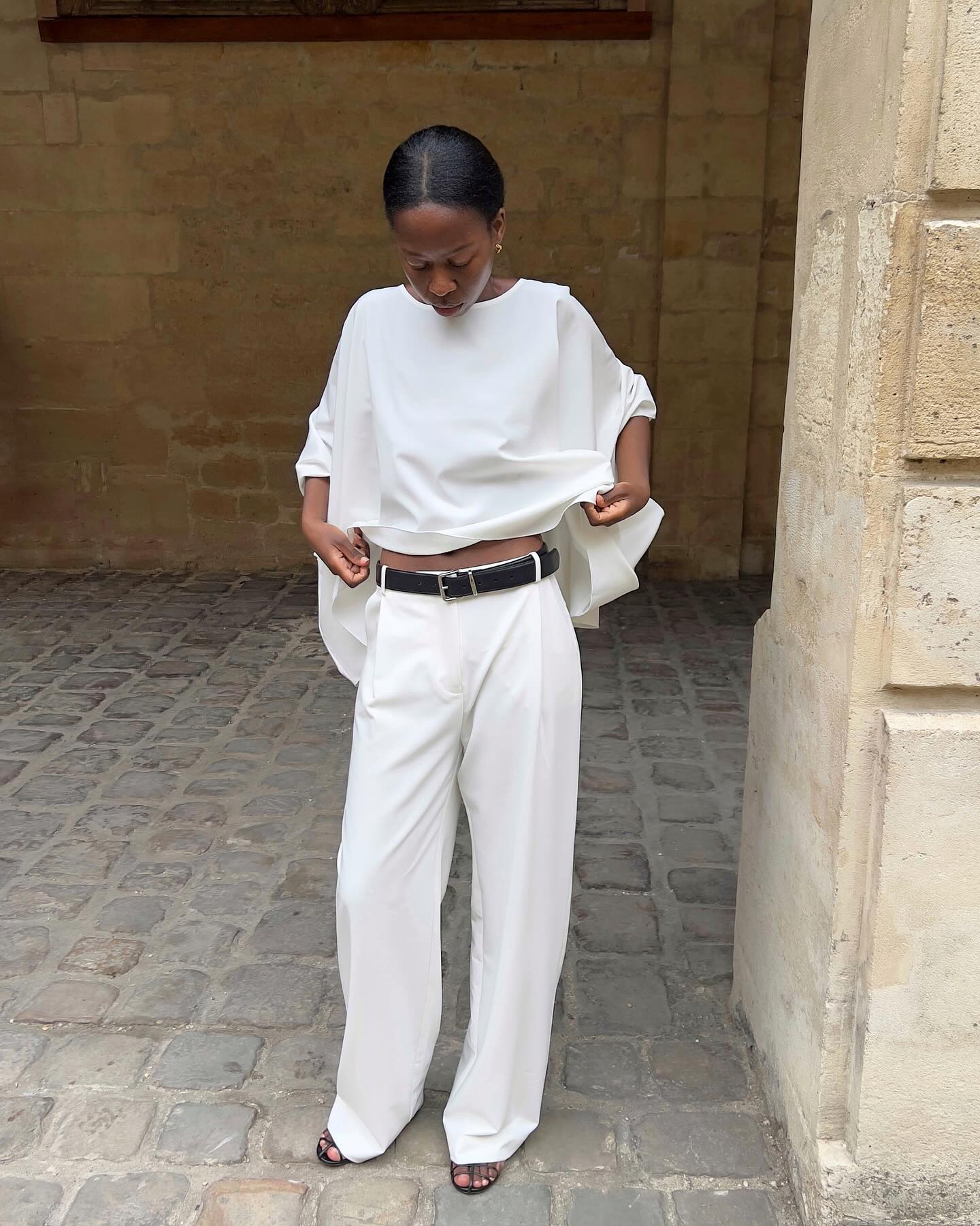 Sylvie in white cape top and tailored trousers