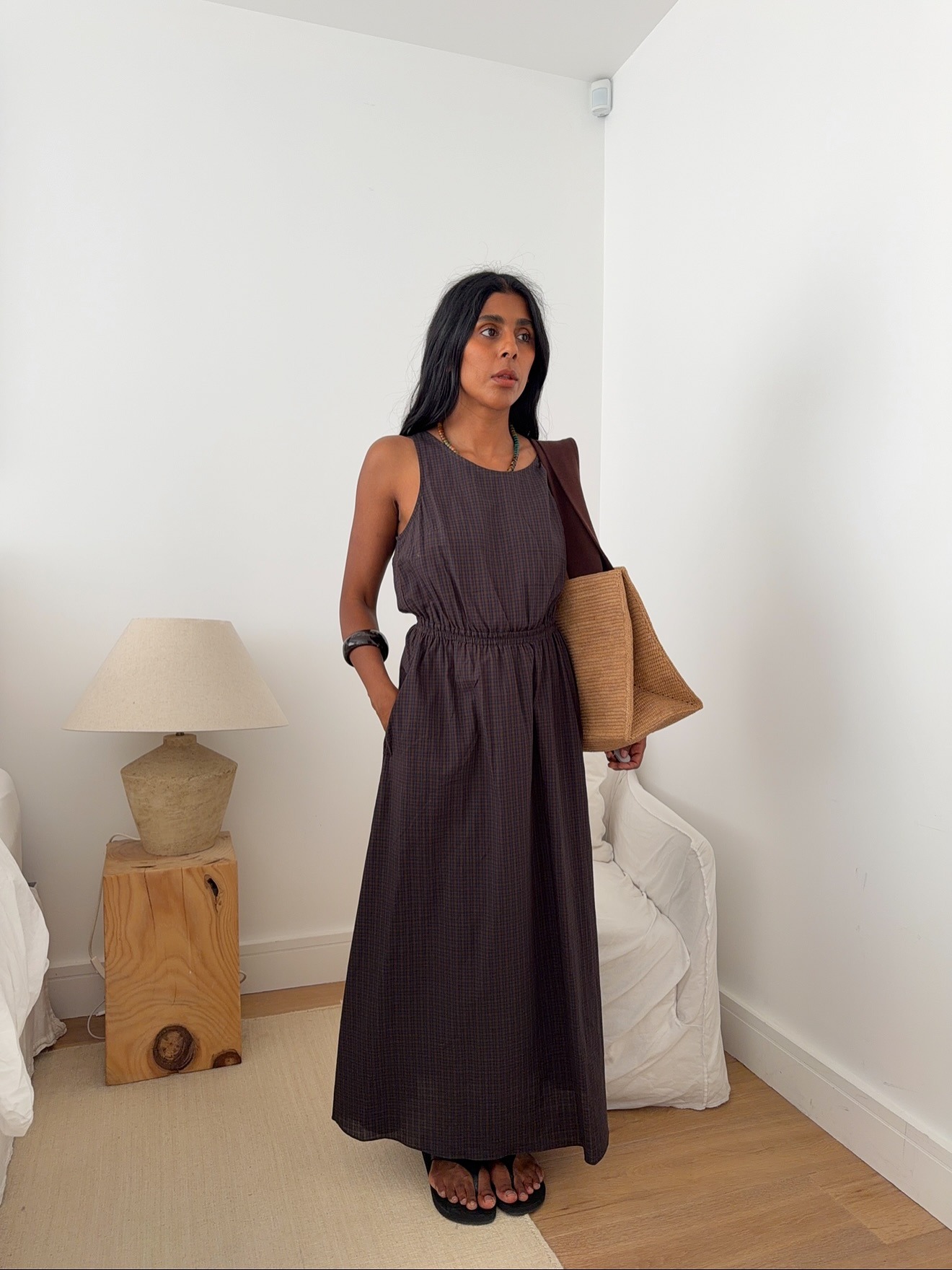 Woman wearing summer dress with flip-flops.