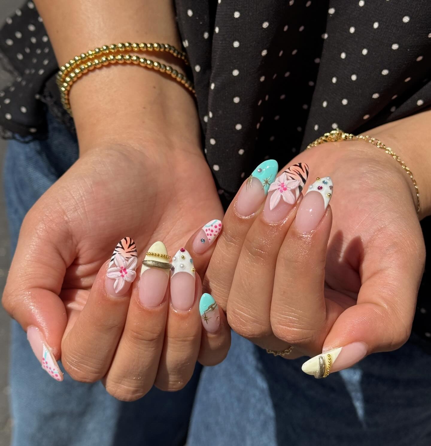 Colourful floral nail art with turquoise French tips