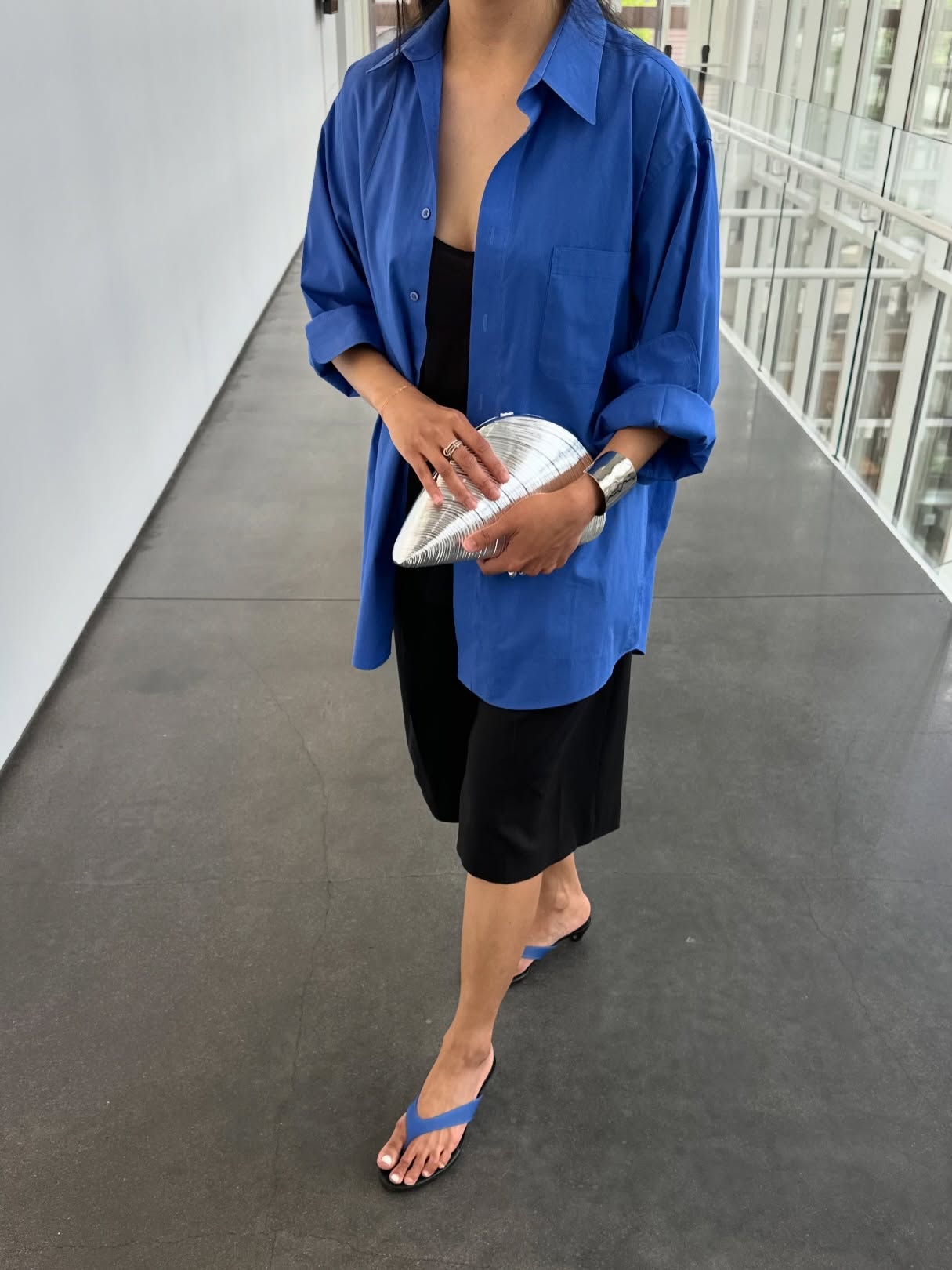 Dawn in blue button-down, Bermuda shorts and blue flip-flops