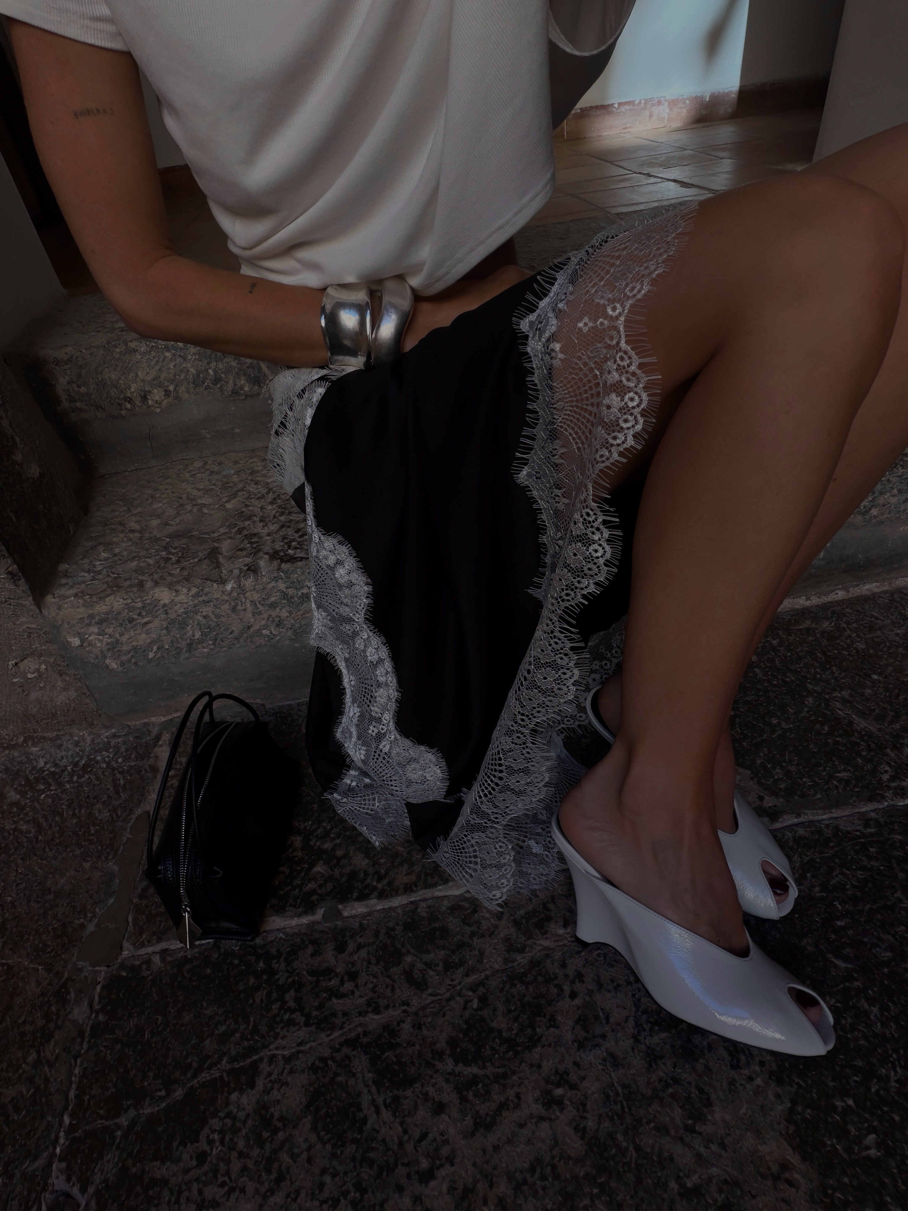 Hannah wearing lace-trim skirt and white micro wedges