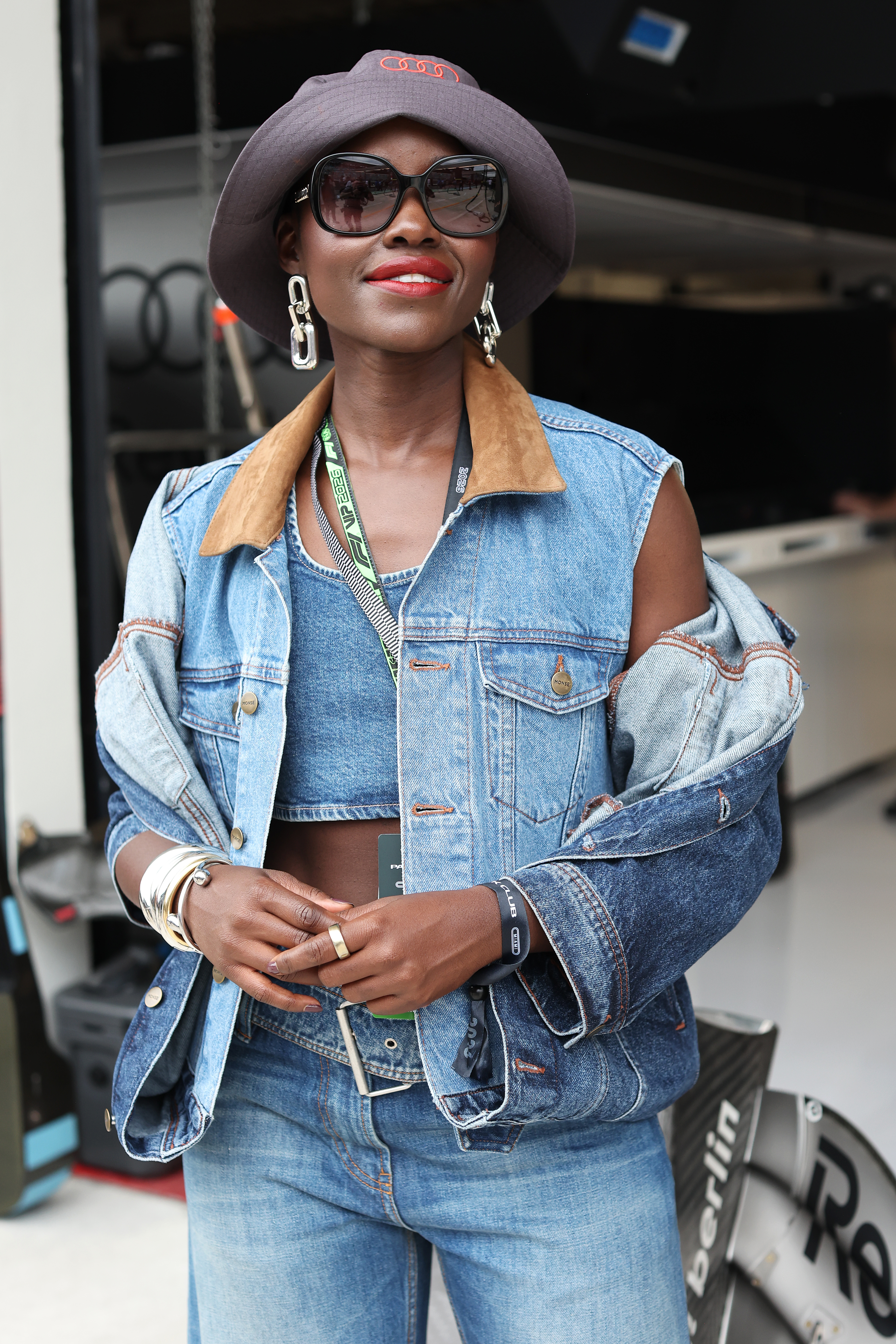 MIAMI, FLORIDA - MAY 03: Lupita Nyong'o poses for a photo in front of the Audi F1 Team garage prior to the F1 Grand Prix of Miami at Miami International Autodrome on May 03, 2026 in Miami, Florida. (Photo by John Phillips/LAT Images)