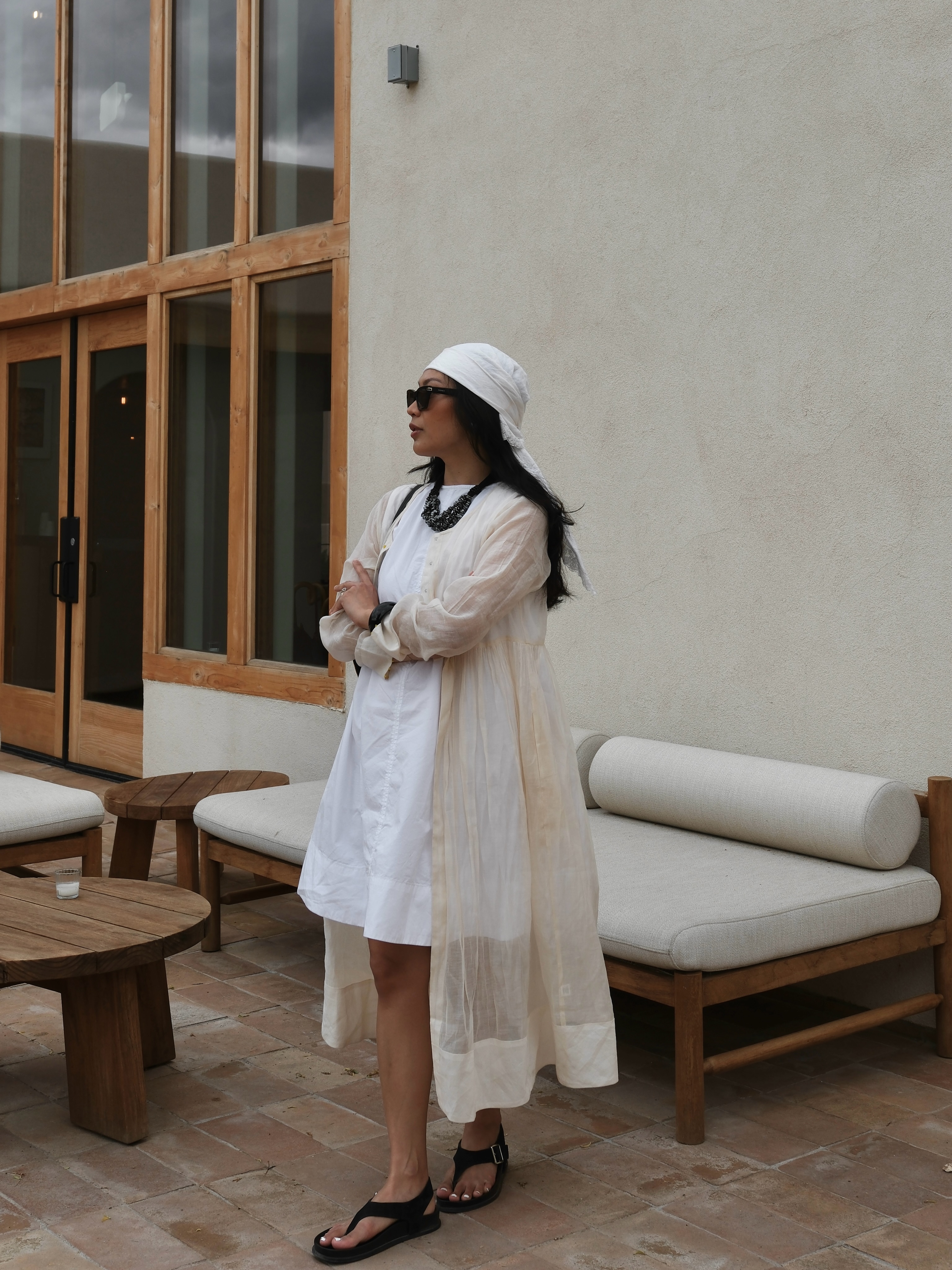 Dawn in white mini dress, duster and head scarf