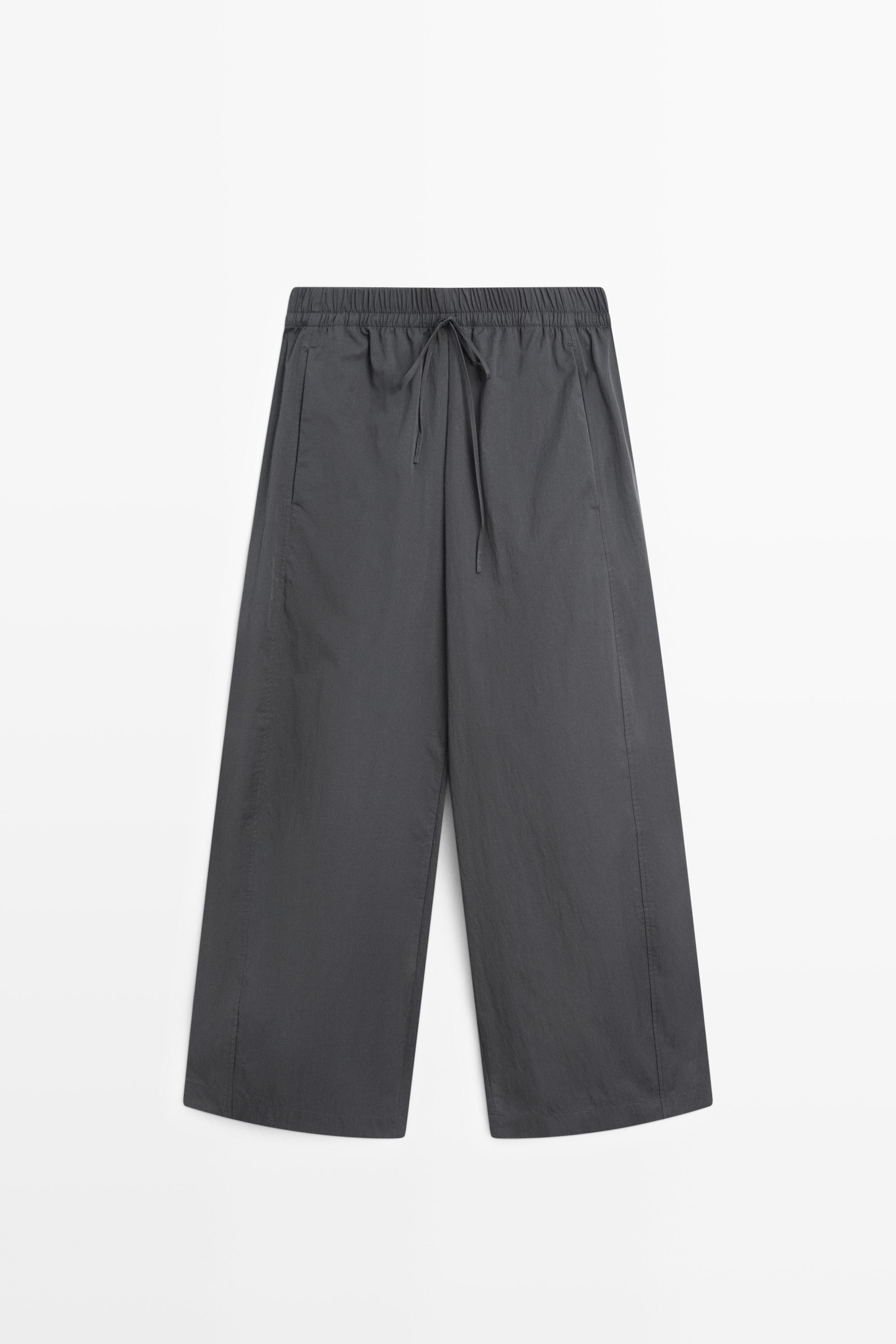 A pair of grey Massimo Dutti barrel-leg trousers.